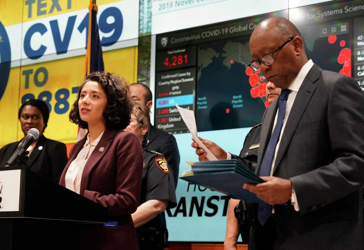 Harris County Judge Lina Hidalgo, left, and Houston Mayor Sylvester Turner, right, with others hold a COVID-19 news conference at Houston TranStar, 6922 Katy Road, Monday, March 16, 2020, in Houston. They announced that starting tomorrow for 15 days, restaurants with be takeout only and all bars will be closed.