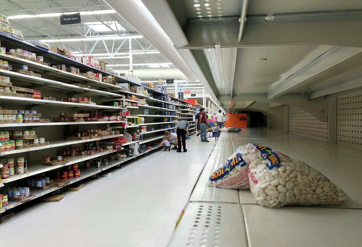 Shelves cleared of groceries at a Walmart in Jacksonville, Fla., on Sunday, March 22, 2020. 