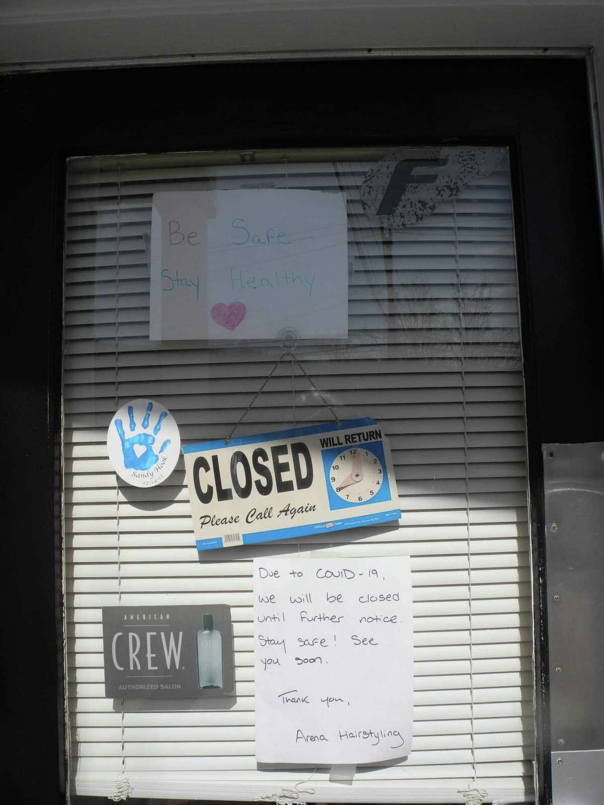 The "closed" sign at Arena Hairstyling is indicative of some, but not all Wilton businesses.
