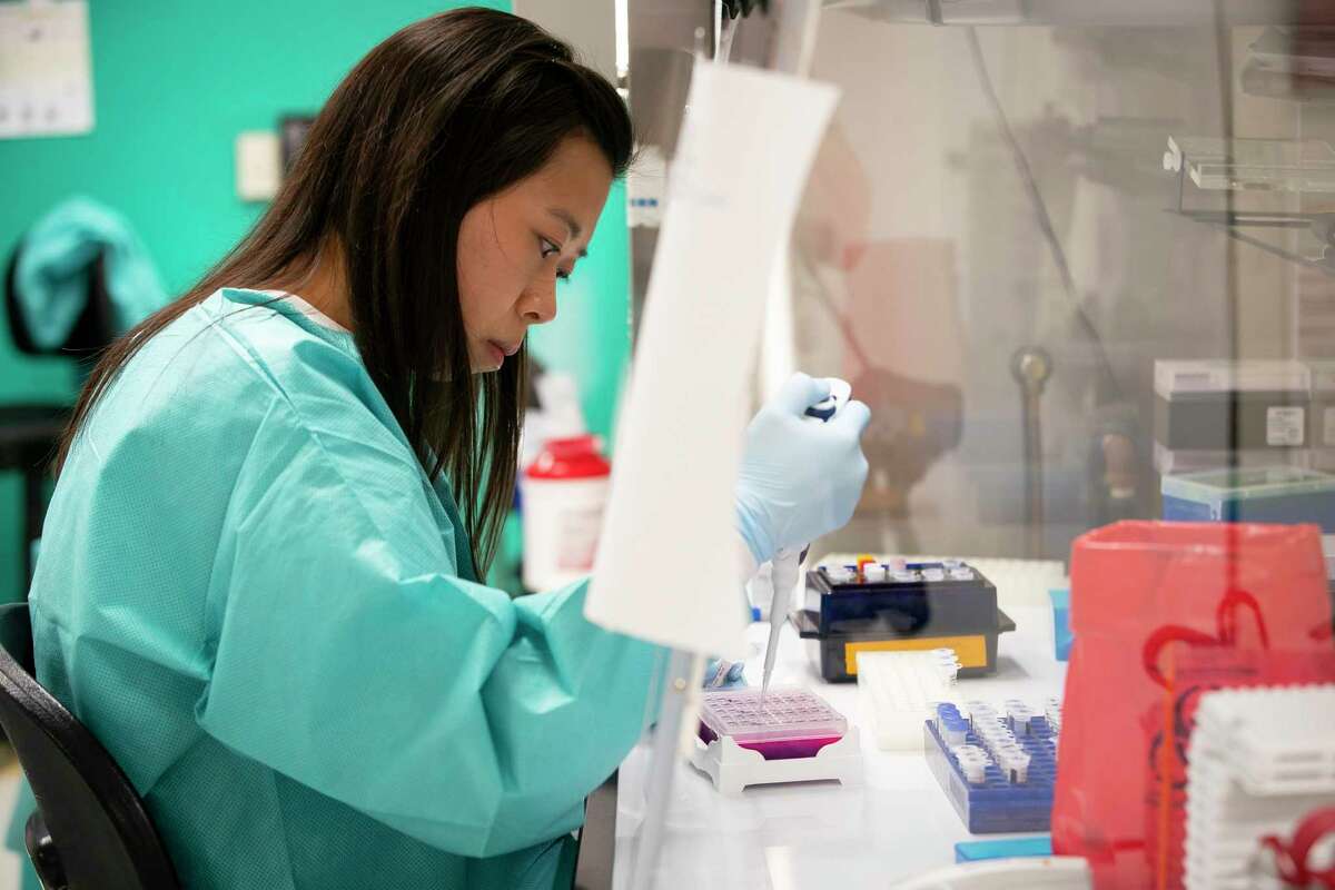 Erica Tam, medical technologist in the molecular microbiology lab, adds the RNA extracted from patient samples collected at the hospital to the test she is running to detect COVID-19 using reagents from a CDC provided test kit, Thursday, March 12, 2020, at Texas Children's Hospital in Houston.