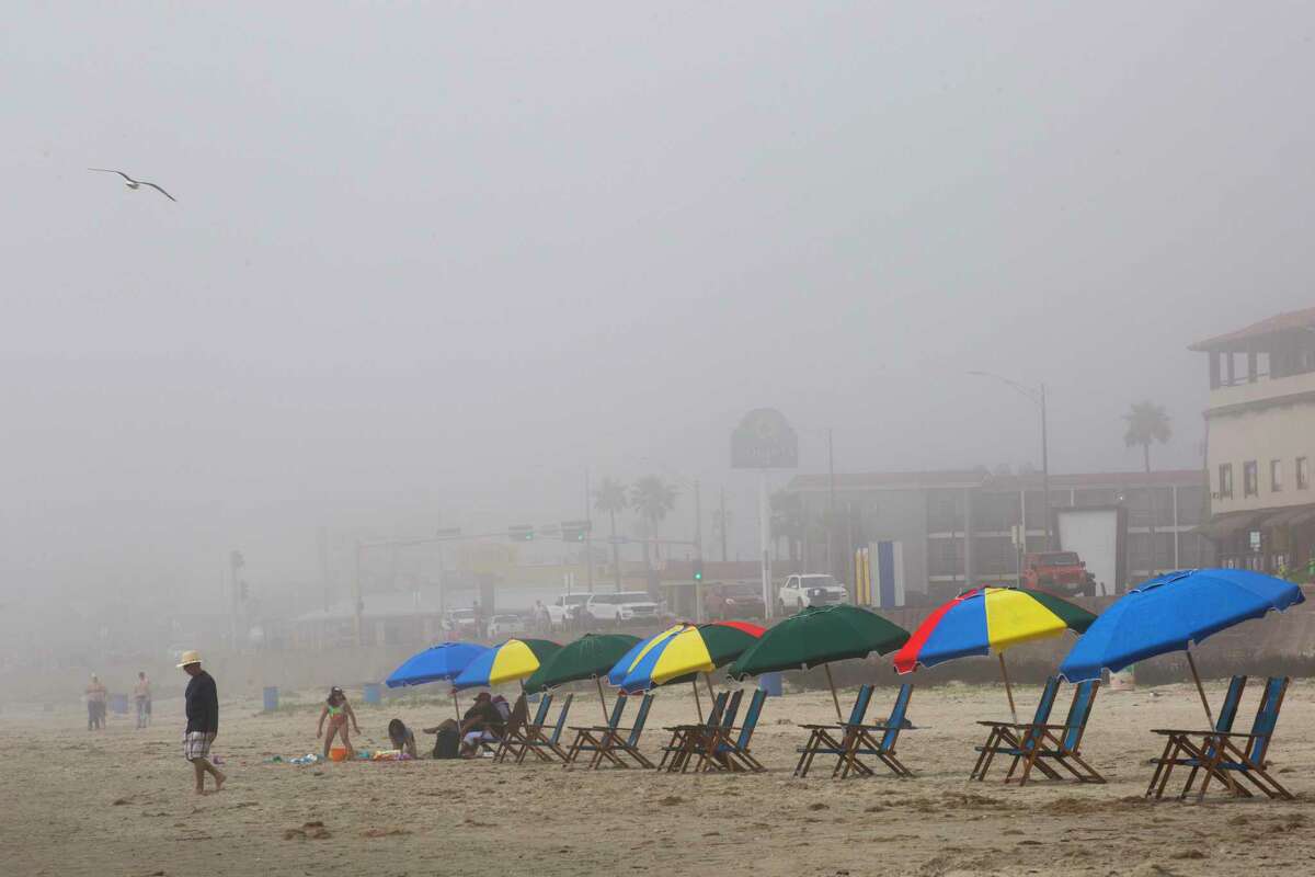 Slowly families start filling the beach chairs at the beach in Galveston early Sunday, March 15, 2020.