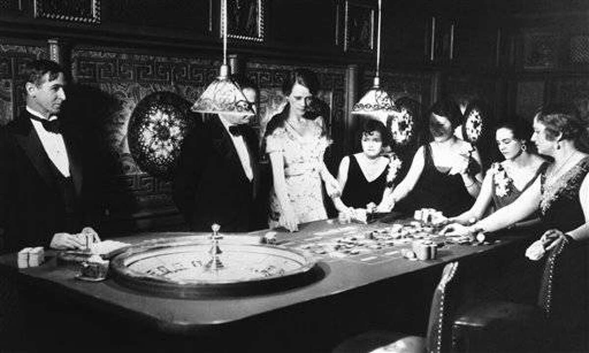 Photo shows gambling in full dress marked the first operation under Nevada?s new Sky-Limit gambling law at one of Reno?s fashionable suburbs in Reno, Nevada, on Saturday, night, March 24, 1931. Here is a roulette table with a few patrons. (AP Photo)
