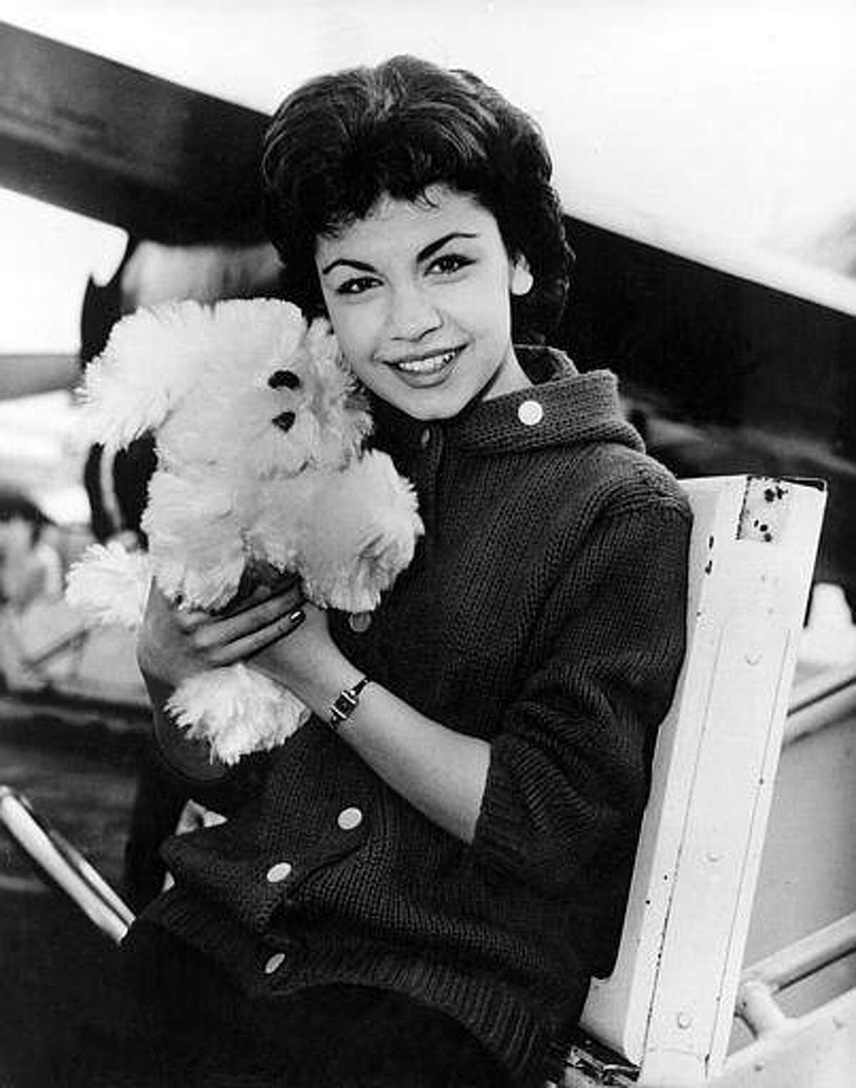 Walt Disney studio’s new star, 16-year-old Annette Funicello, poses with her Shaggy Dog doll, at Idlewild Airport in New York, on March 24, 1959. (AP Photo)