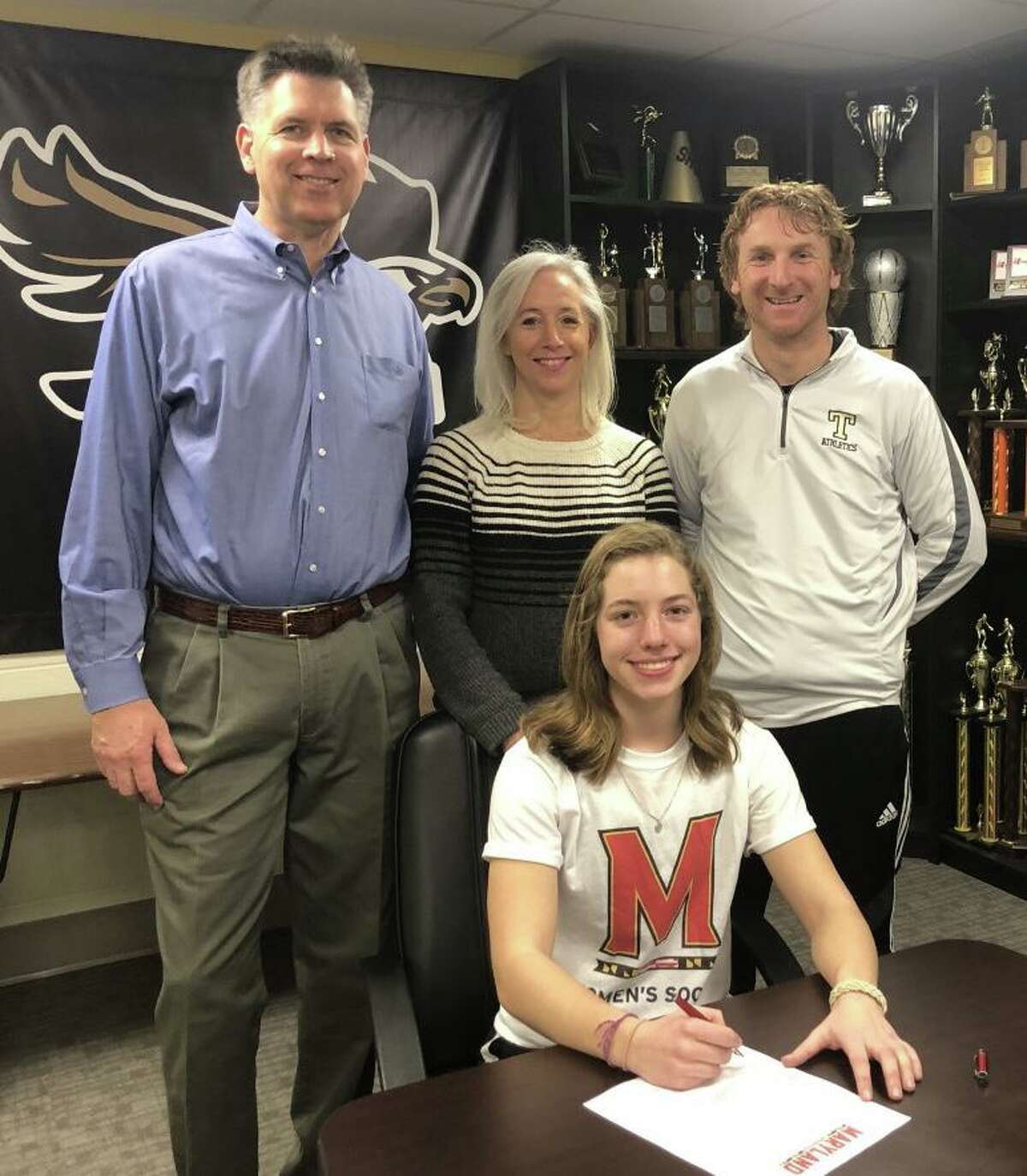 Avery Rice was joined by dad Conway, mom Marybeth and Trumbull head girls' soccer coach Rich Sutherland when she signed her letter of intent to play soccer at Maryland University.