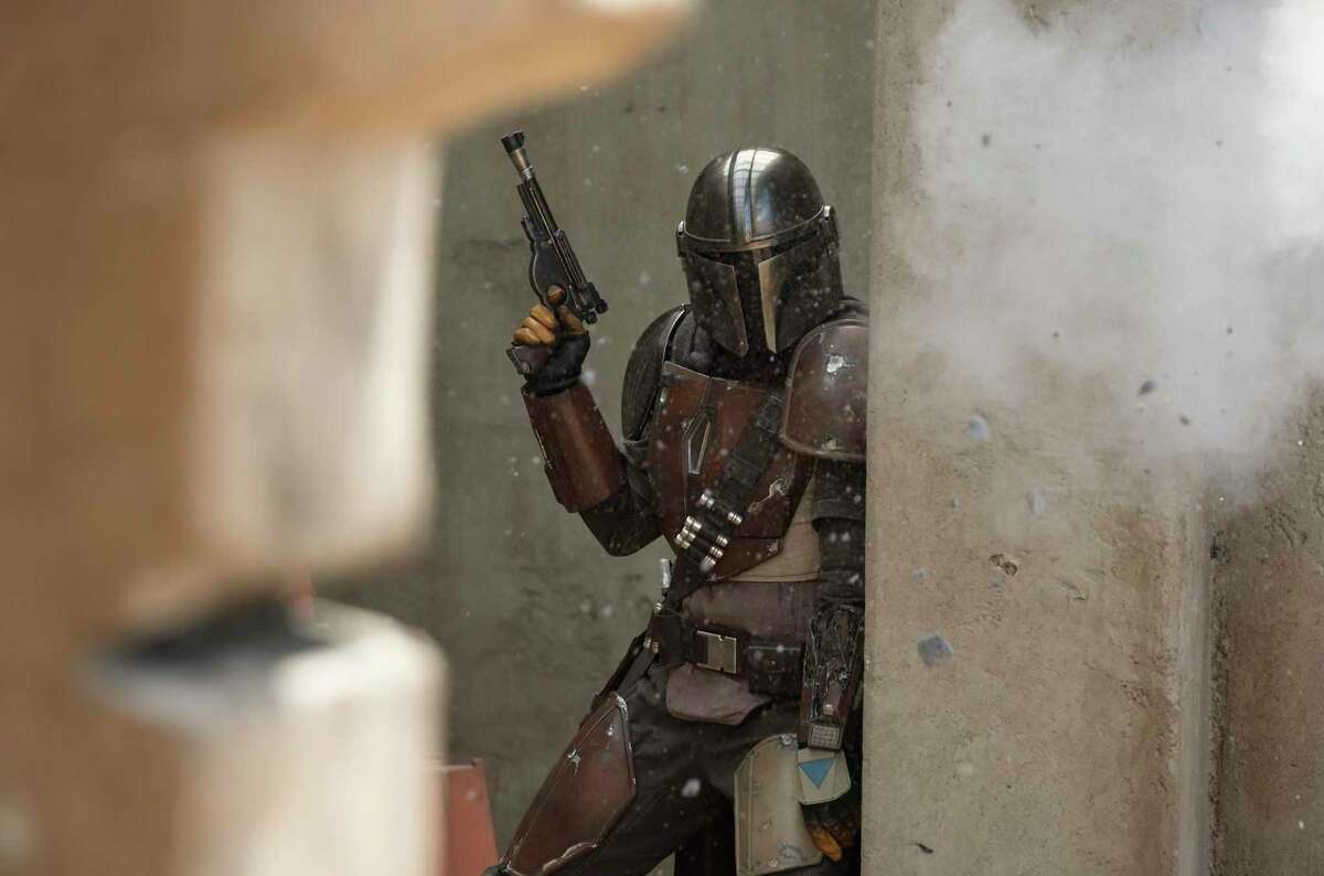 This image released by Disney Plus shows Pedro Pascal in a scene from "The Mandalorian." The streaming service is one of the big winners as Americans staying at home to avoid spreading the coronavirus are signing up for new offerings.