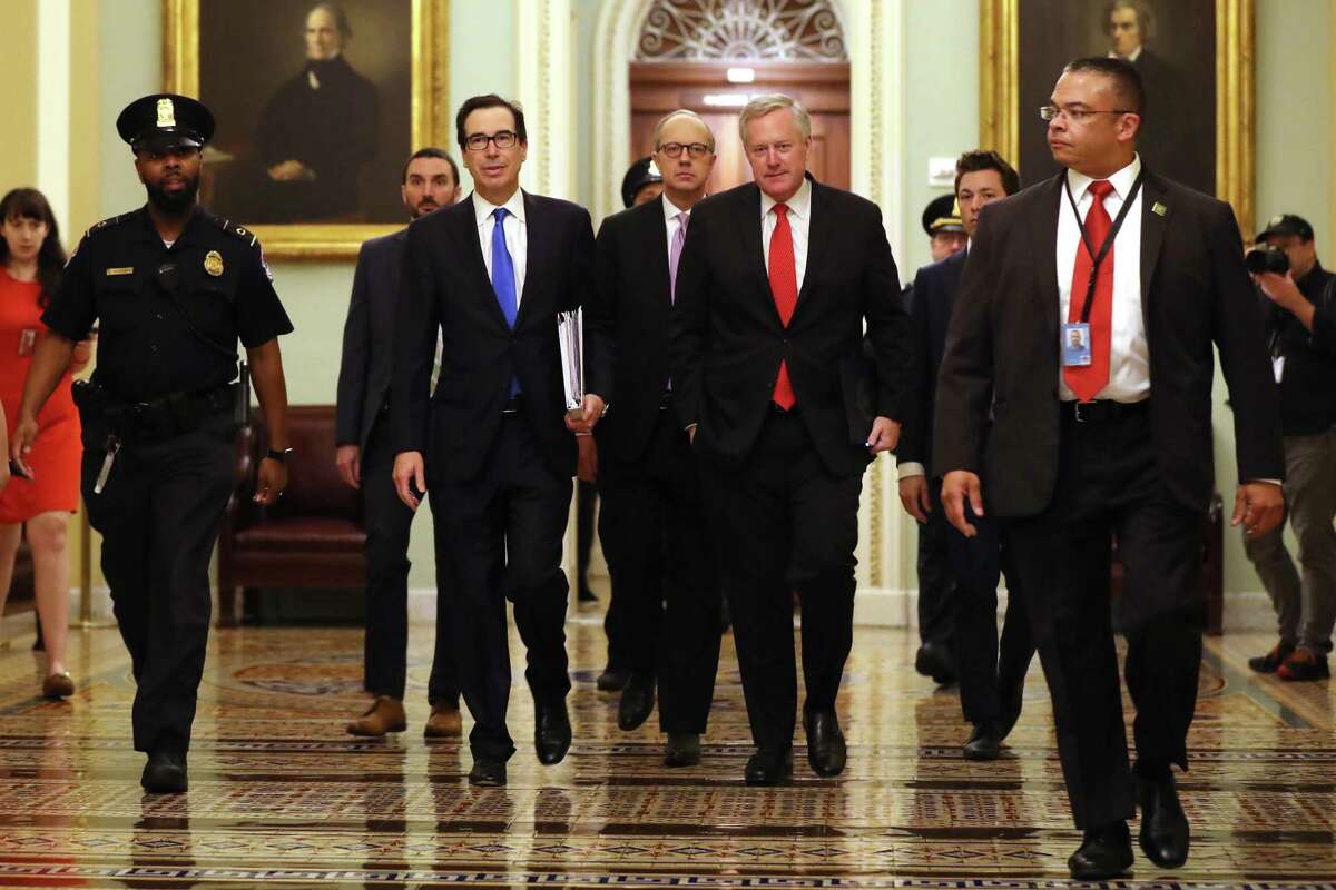 Treasury Secretary Steven Mnuchin (2L), White House Director of Legislative Affairs Eric Ueland (3L) and White House Chief of Staff Mark Meadows) arrive at the Capitol to continue negotiations on a $2 trillion economic stimulus in response to the coronavirus pandemic. After days of tense negotiations -- and Democrats twice blocking the nearly $2 trillion package -- the Senate and Treasury Department appear to have reached important compromises on legislation to shore up the economy during the COVID-19 pandemic.