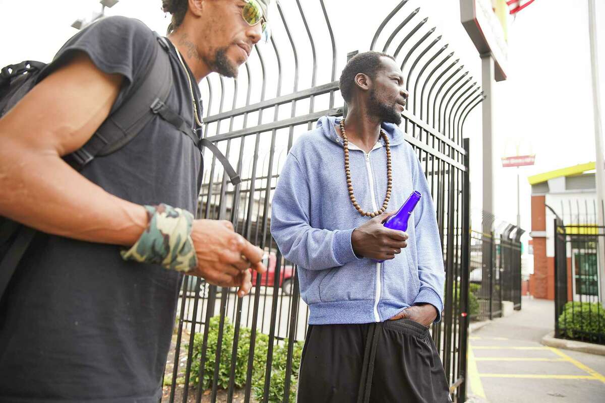 Local men who are homeless hang out on Main Street in downtown Houston.