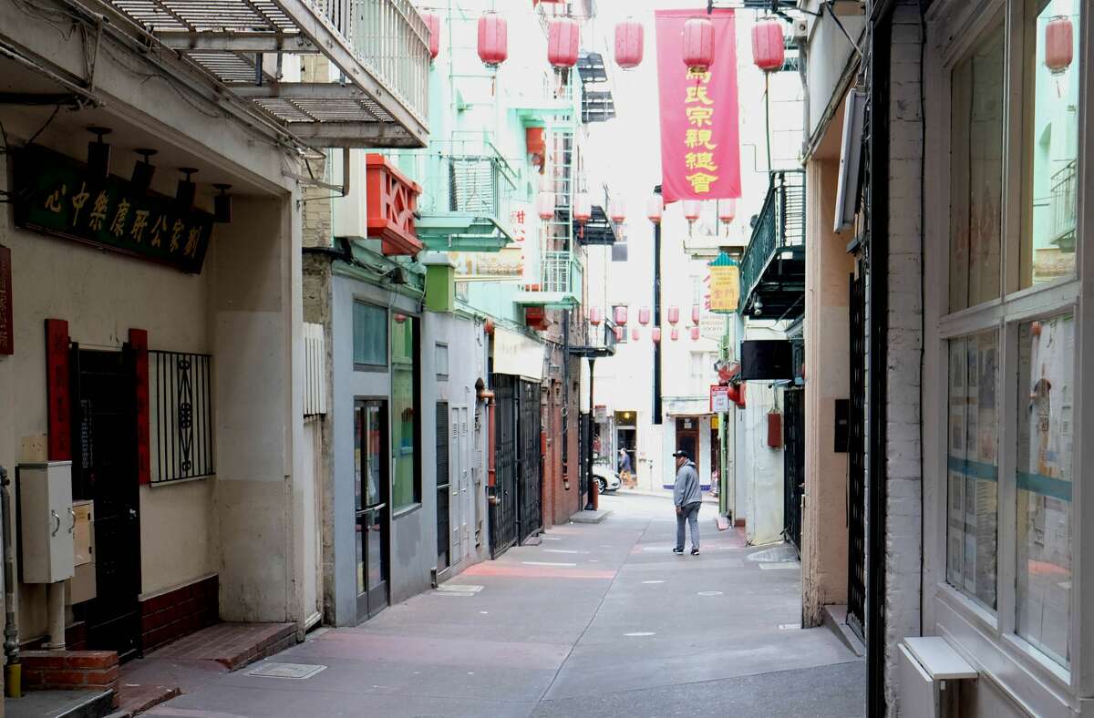 FILE - The store owner Kevin Chan walks in the alley where his Golden Gate Fortune Cookie Factory is located in San Francisco's Chinatown, California, the United States, March 20, 2020.