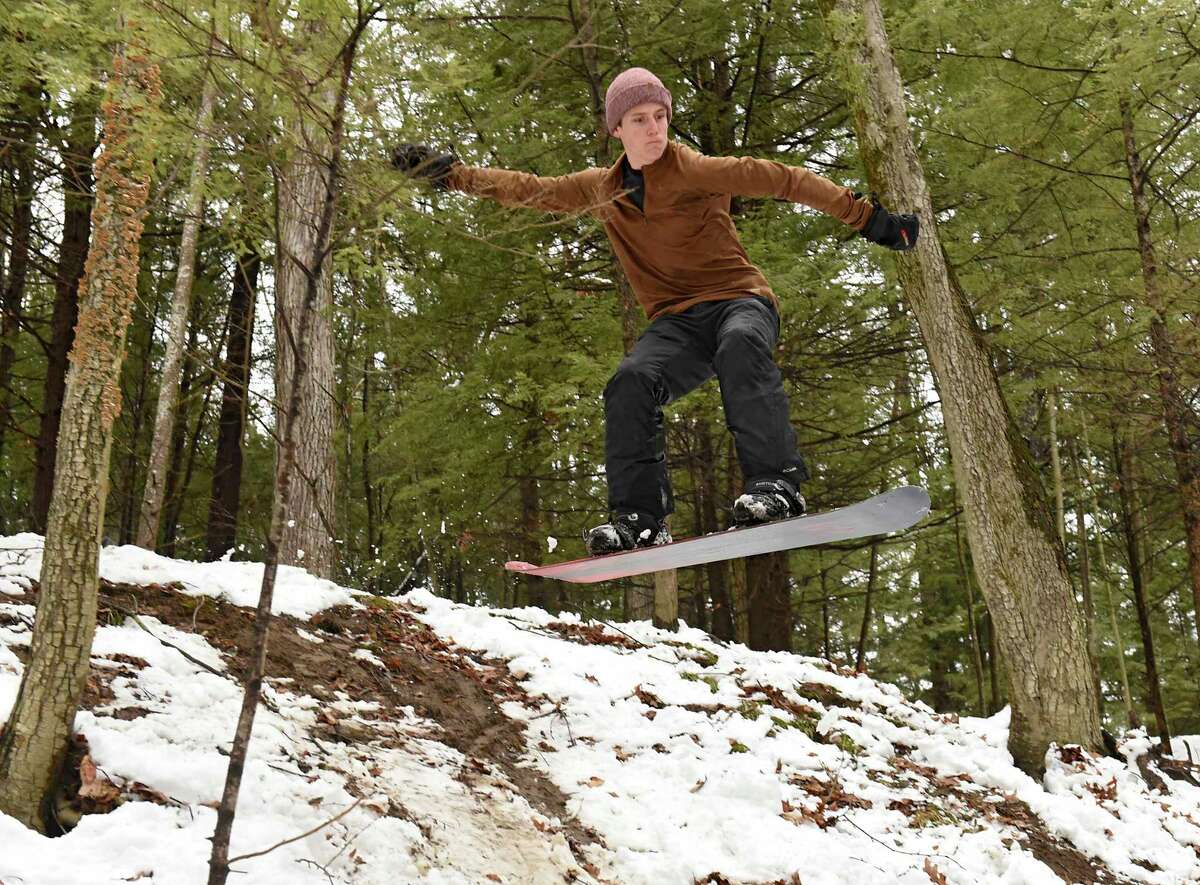 Cole Sgambati, 17, of Saratoga Springs flies down a hill on his snowboard through woods in Saratoga Spa State Park on Tuesday, March 24, 2020 in Saratoga Springs, N.Y (Lori Van Buren/Times Union)