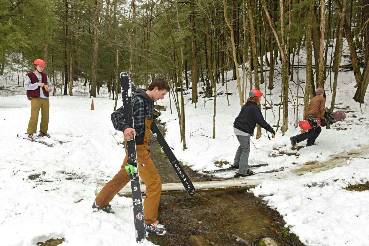 Teenagers from Saratoga Springs make the most of fresh fallen snow by snowboarding and skiing down hills in the woods in Saratoga Spa State Park on Tuesday, March 24, 2020 in Saratoga Springs, N.Y (Lori Van Buren/Times Union)
