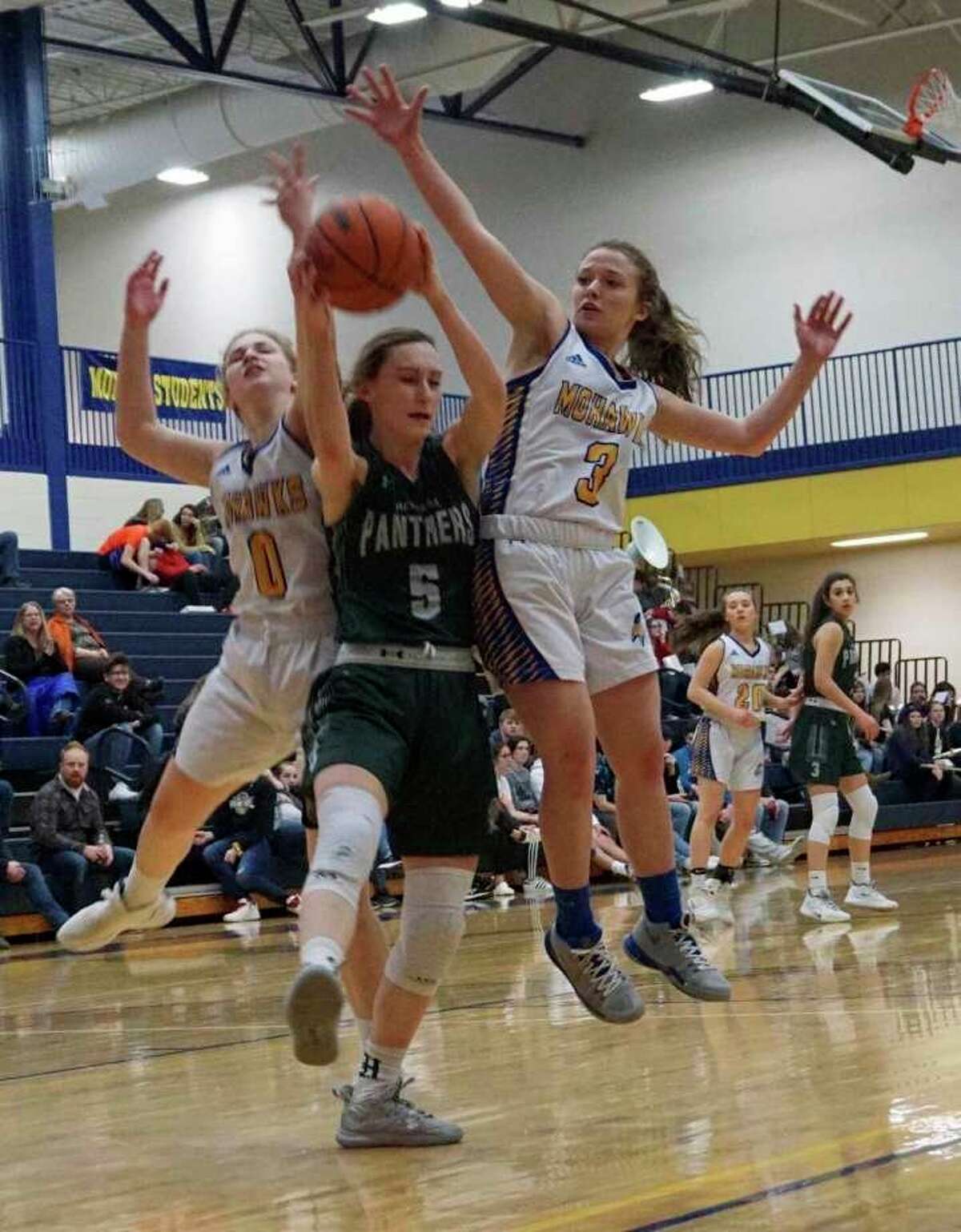Morley Stanwood seniors Emma Doyle and Hailey Dard go up to block an attempt from Hesperia junior Emily Bayle during the regular season. (Pioneer file photo/Joe Judd)