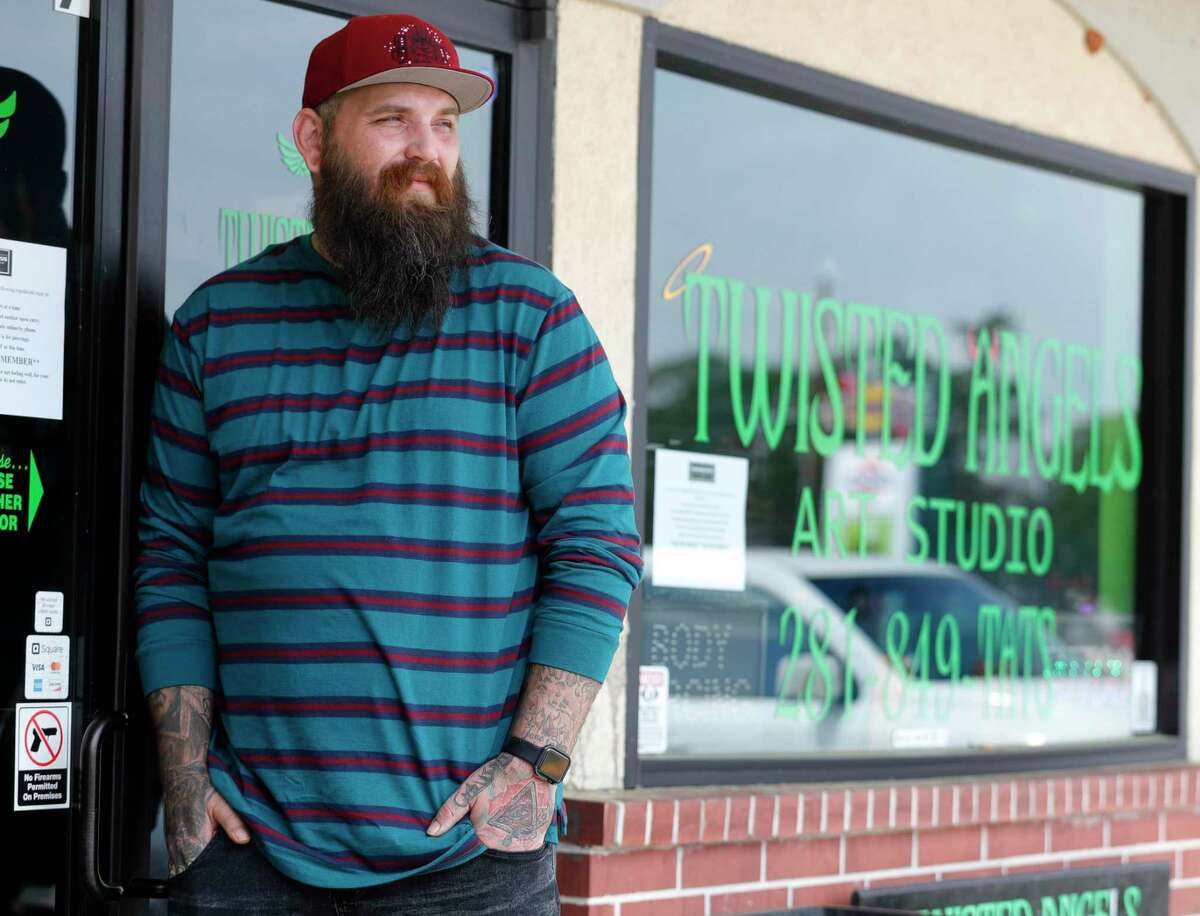 Tattoo artist Dustin “Gil” Gillihan pose for a portrait at Twisted Angels Art Studio, Tuesday, March 24, 2020, in Conroe.