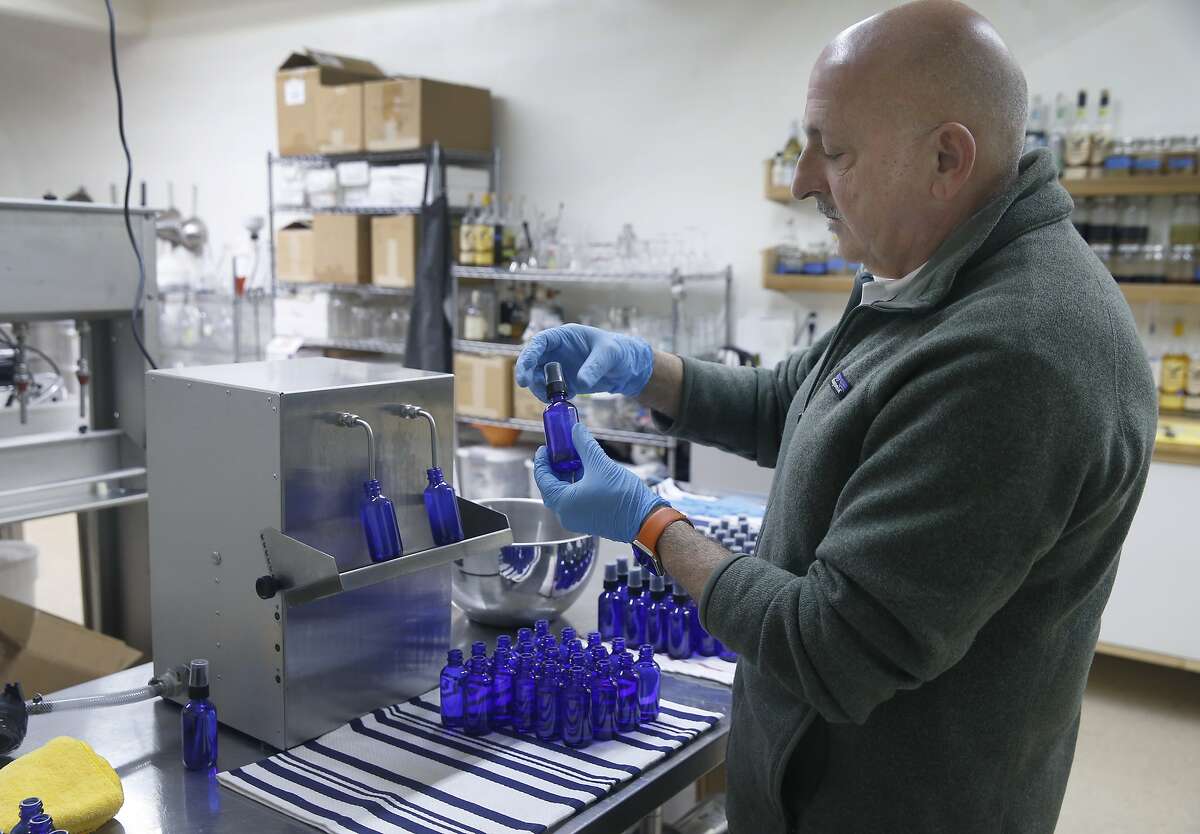 Farid Dormishian fills four ounce bottles with hand sanitizer at his Falcon Spirits distillery in Richmond, Calif. on Tuesday, March 24, 2020. Dormishian suspended production of the spirits during the coronavirus pandemic. The hand sanitizer will be distributed to municipalities like Berkeley and first responders.
