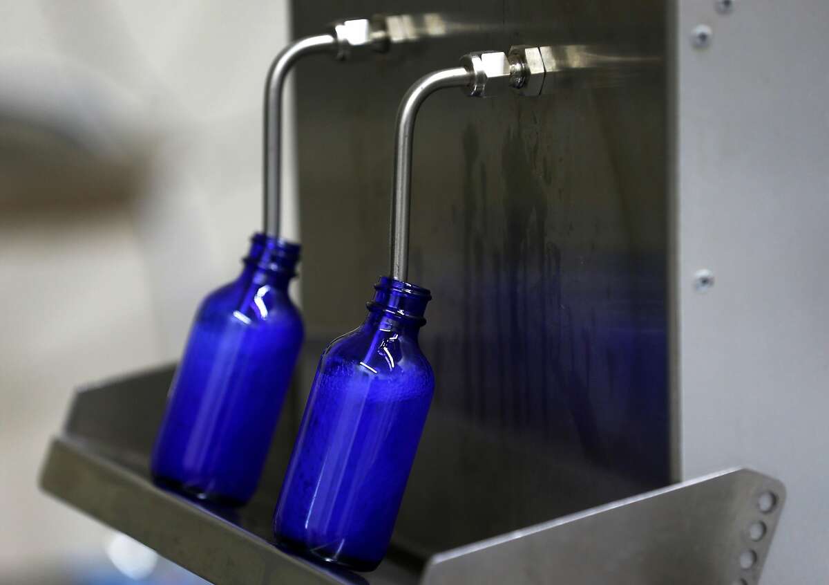 Four ounce bottles are filled with hand sanitizer produced at the Falcon Spirits distillery in Richmond, Calif. on Tuesday, March 24, 2020. Owner Farid Dormishian suspended production of the spirits during the coronavirus pandemic. The hand sanitizer will be distributed to municipalities like Berkeley and first responders.