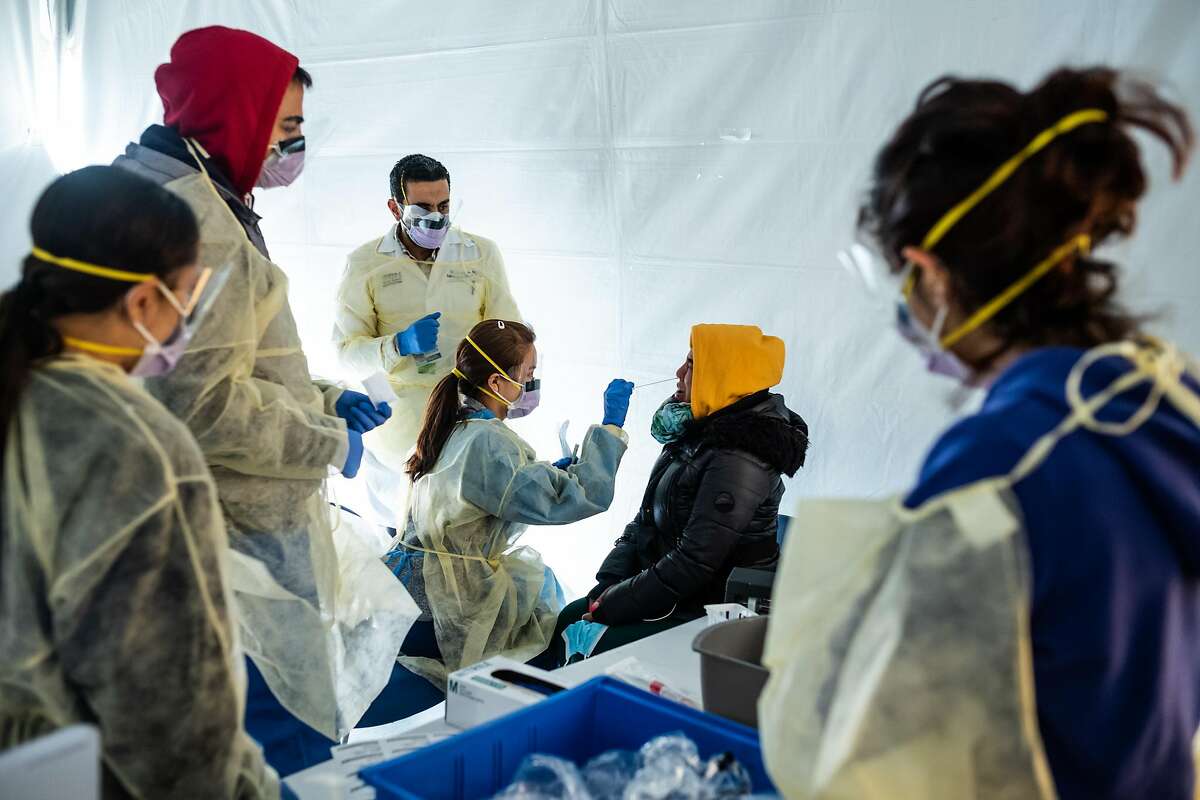 NEW YORK, NY - MARCH 24: Doctors test hospital staff with flu-like symptoms for coronavirus (COVID-19) in set-up tents to triage possible COVID-19 patients outside before they enter the main Emergency department area at St. Barnabas hospital in the Bronx