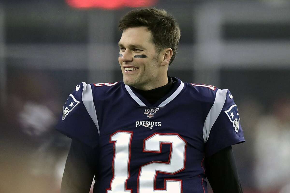 New England Patriots' Tom Brady (12) and Brian Hoyer (2) warm up before the  NFL Super