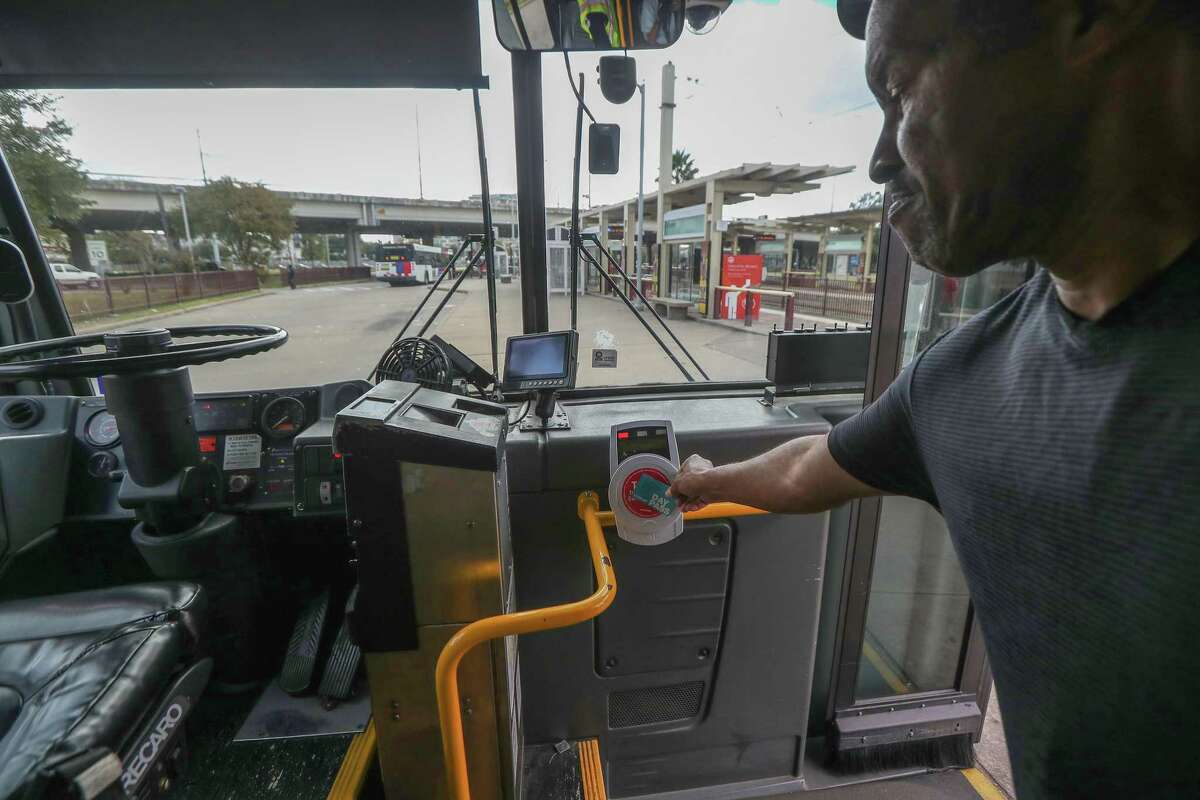 Metropolitan Transit Authority bus riders use Q cards, phone Apps or cash to ride on Nov. 20, 2019, in Houston. Metro waived fares this week to avoid unnecessary contact on transit in light of the coronavirus fears.