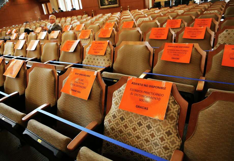 Signage is placed on chairs to observe social distancing during a meeting by Mayor Ron Nirenberg and the City Council as they discuss extending the latest Coronavirus emergency declaration to 30 days on Thursday, Mar. 19, 2020. Two council members: District 8's Manny Peláez and District 3's Rebecca J. Viagran were present via video-conferencing since both are self-quarantining from their homes. The meeting was held under attendance restriction on no more than 50 people and seating in the room observed social distancing with signage included. Photo: Kin Man Hui, San Antonio Express-News / Staff Photographer / **MANDATORY CREDIT FOR PHOTOGRAPHER AND SAN ANTONIO EXPRESS-NEWS/NO SALES/MAGS OUT/ TV OUT
