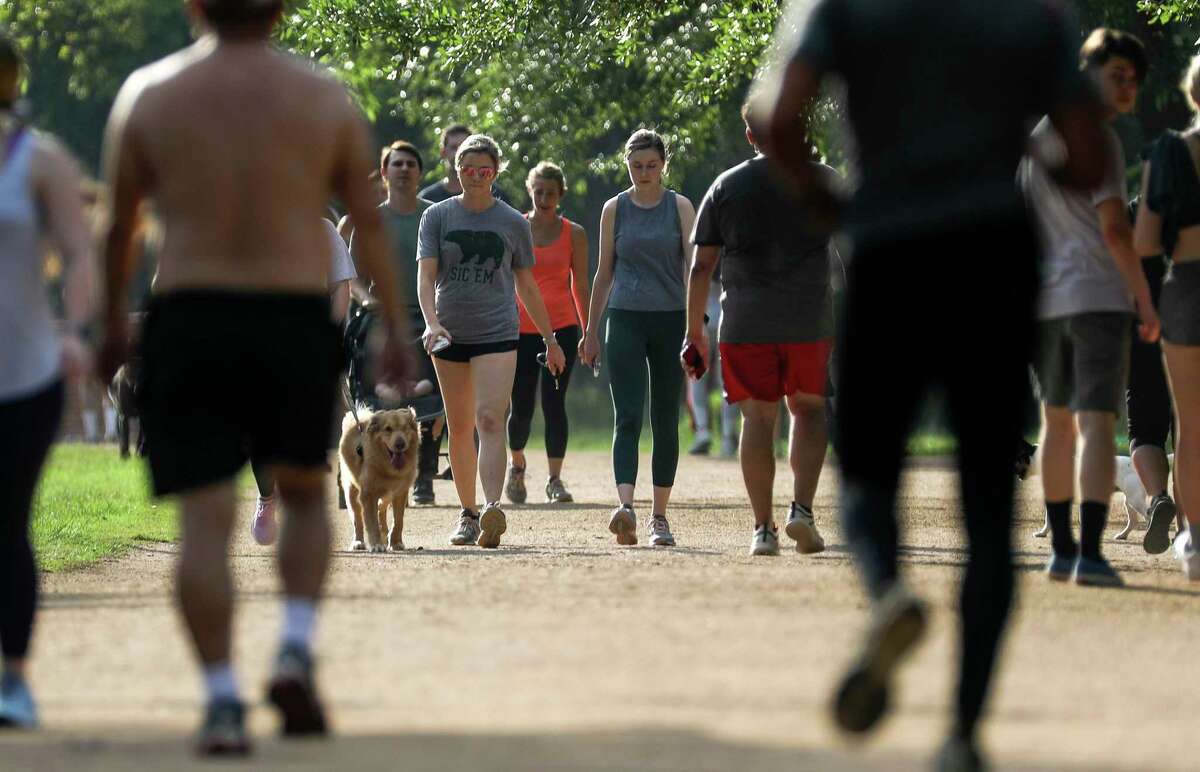 People exercise in Memorial Park on Tuesday, March 24, 2020, in Houston.