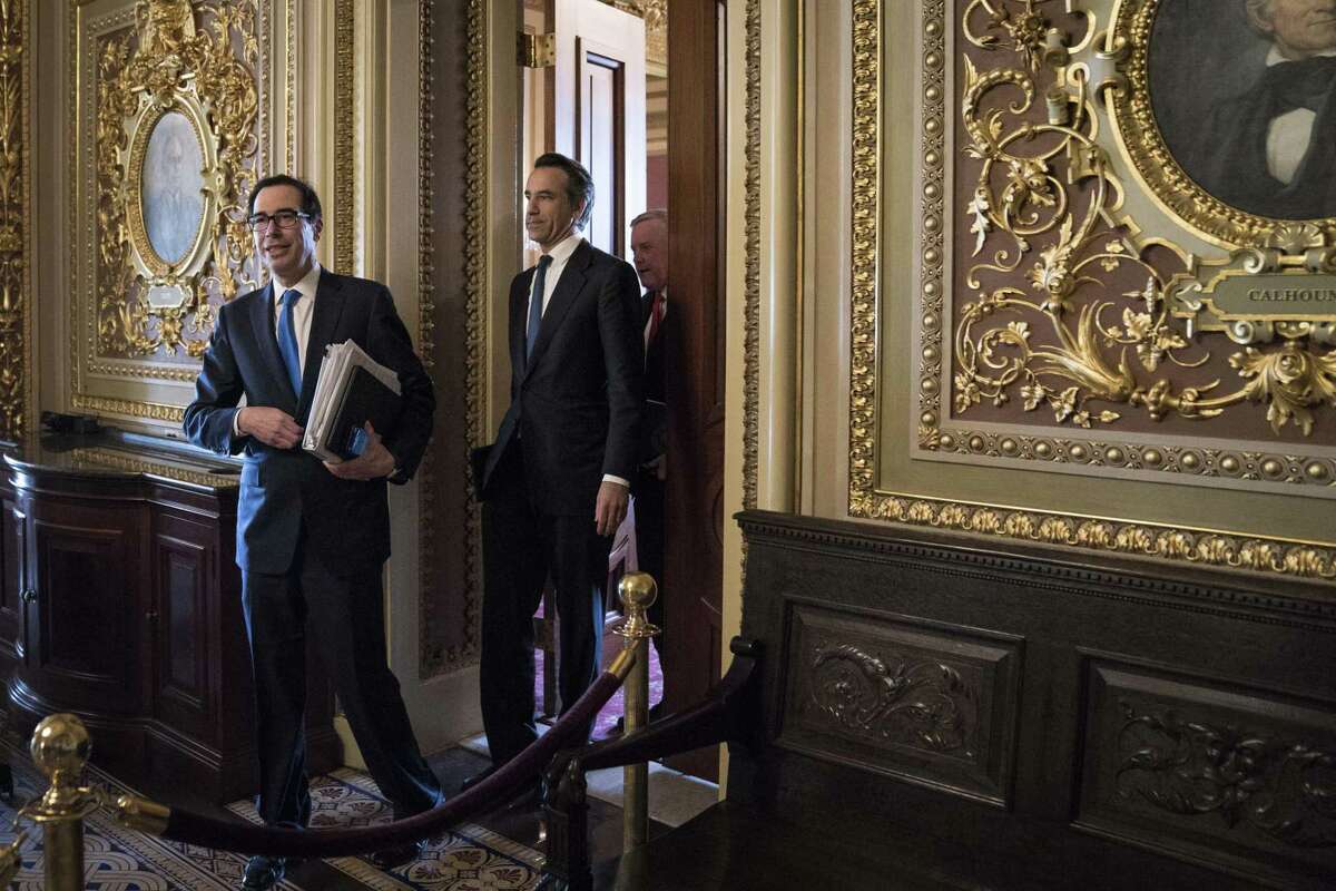 Steven Mnuchin, U.S. Treasury secretary, left, and Mark Meadows, White House chief of staff, in the Capitol. They reached a deal on a $2 trillion stimuls package early Wednesday.