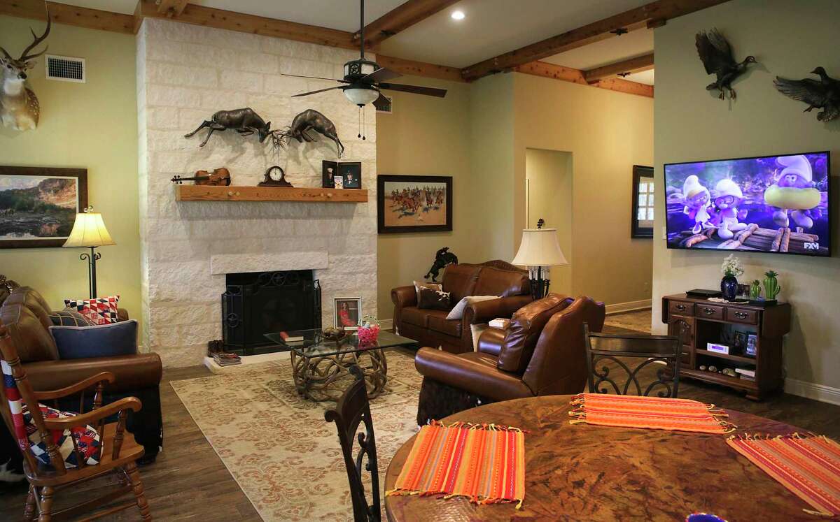 The family room has a large, limestone-faced fireplace.