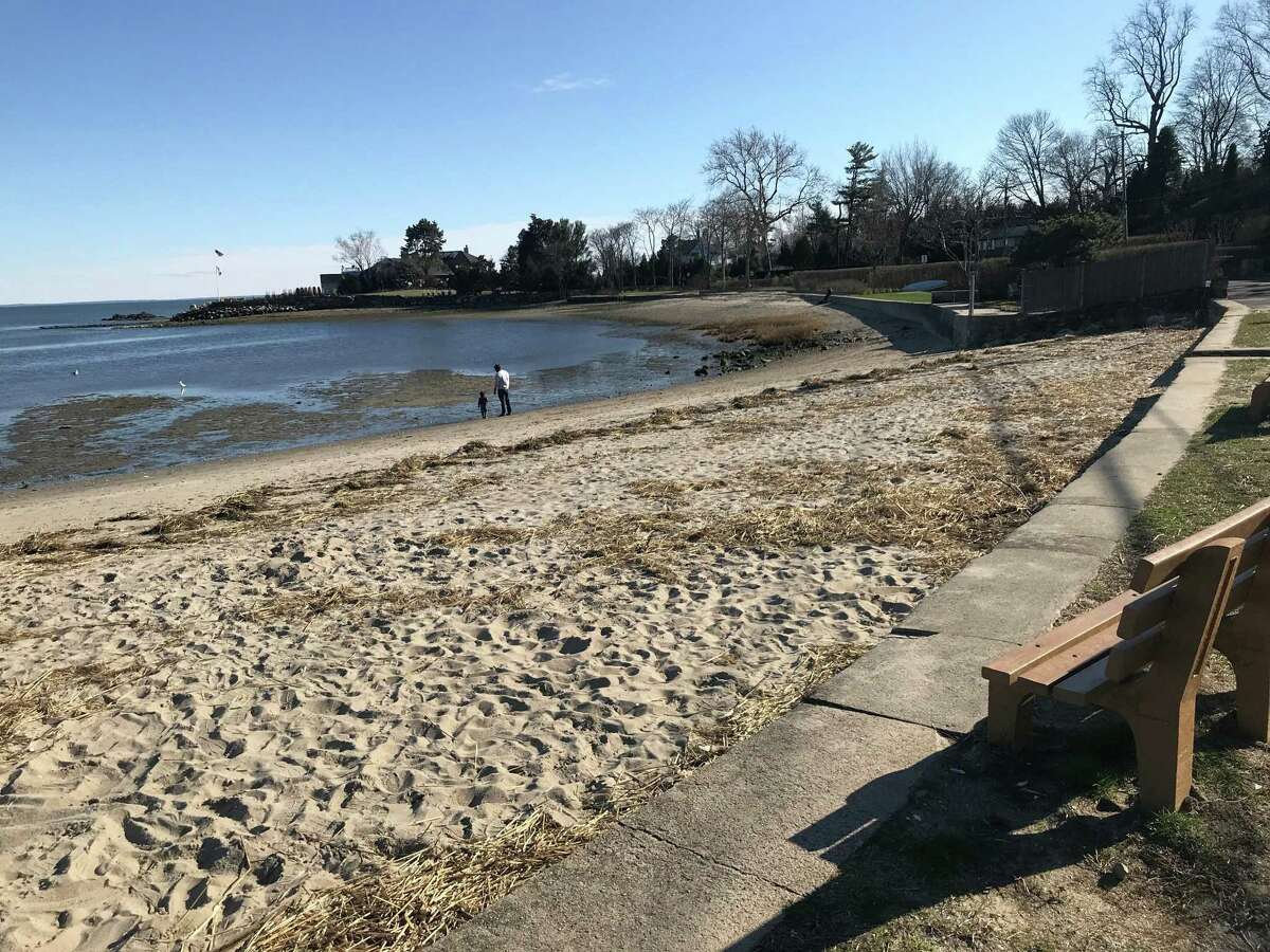 A parent and their child enjoy the relatively empty Compo Beach area late Tuesday afternoon. Taken March 24, 2020 in Westport, Conn.