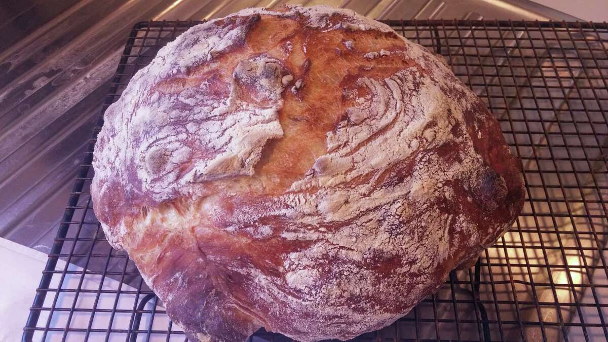 A homemade dark, crusty, bakery-style loaf of bread from Jim Lahey’s no-knead recipe.