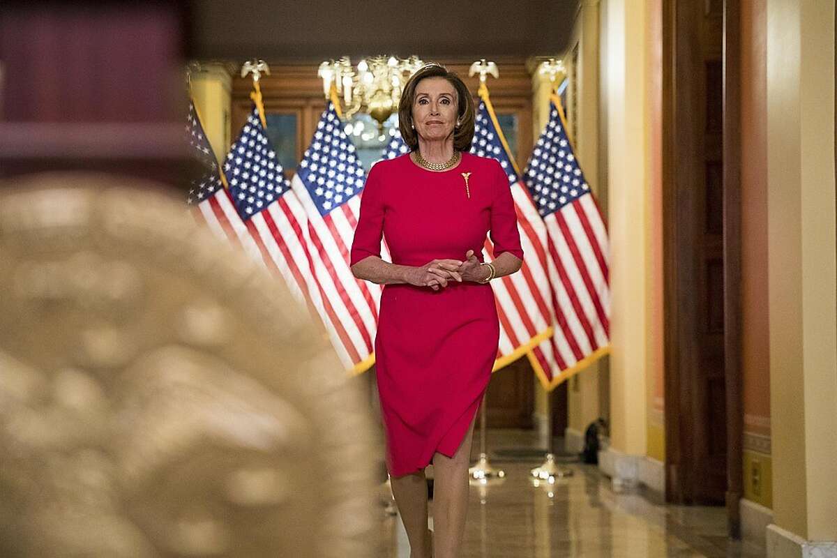 House Speaker Nancy Pelosi of California arrives to read a statement outside her office on Capitol Hill, March 23, 2020, in Washington.