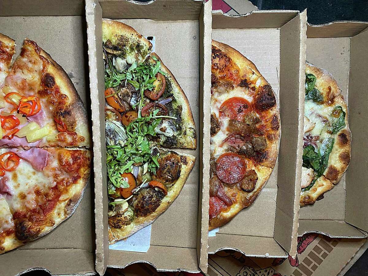 Pizza choices include, from left, Hawaiian Fresno, Screaming Vegan, Ultimate Meat Lovers and White Delight at The Last Slice.