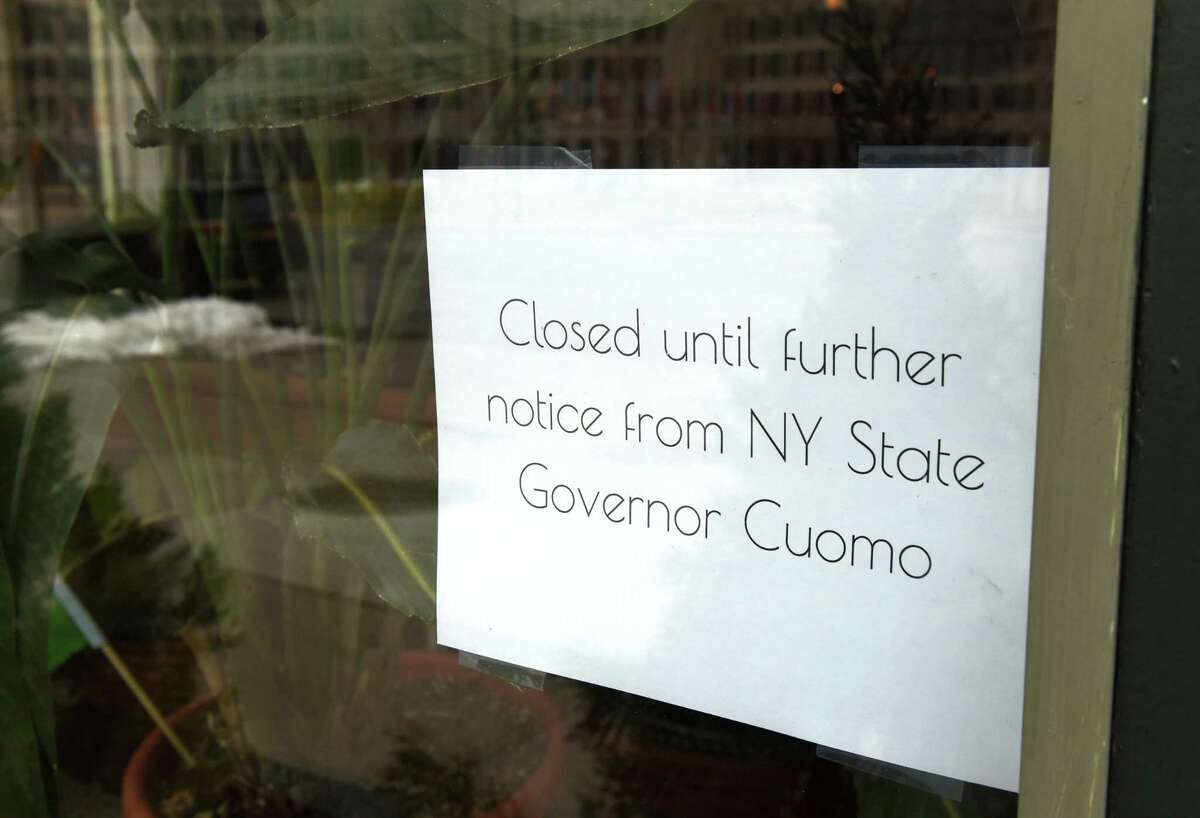 A state coronavirus lockdown notice is seen in the window at Loch & Quay on Wednesday, March 25, 2020, on Broadway in Albany, N.Y. “The coronavirus crisis has turned life upside down for nearly all New Yorkers,” said Don Levy, the director of the Siena College Research Institute.