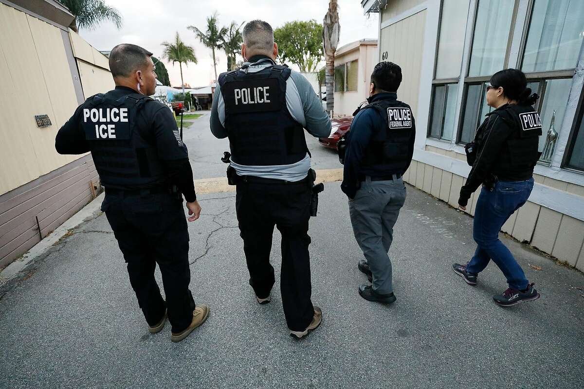 David A. Marin, left, Field Office Director Enforcement and Removal Operations Los Angeles Field Office of U.S. Immigration and Customs Enforcement (ICE) as agents advance on a residence during early morning apprehensions as ICE officers are joined by (CBP) U.S. Customs & Border Protection agents in the last few weeks, as more resources are deployed in sanctuary cities. (Al Seib/Los Angeles Times/TNS)