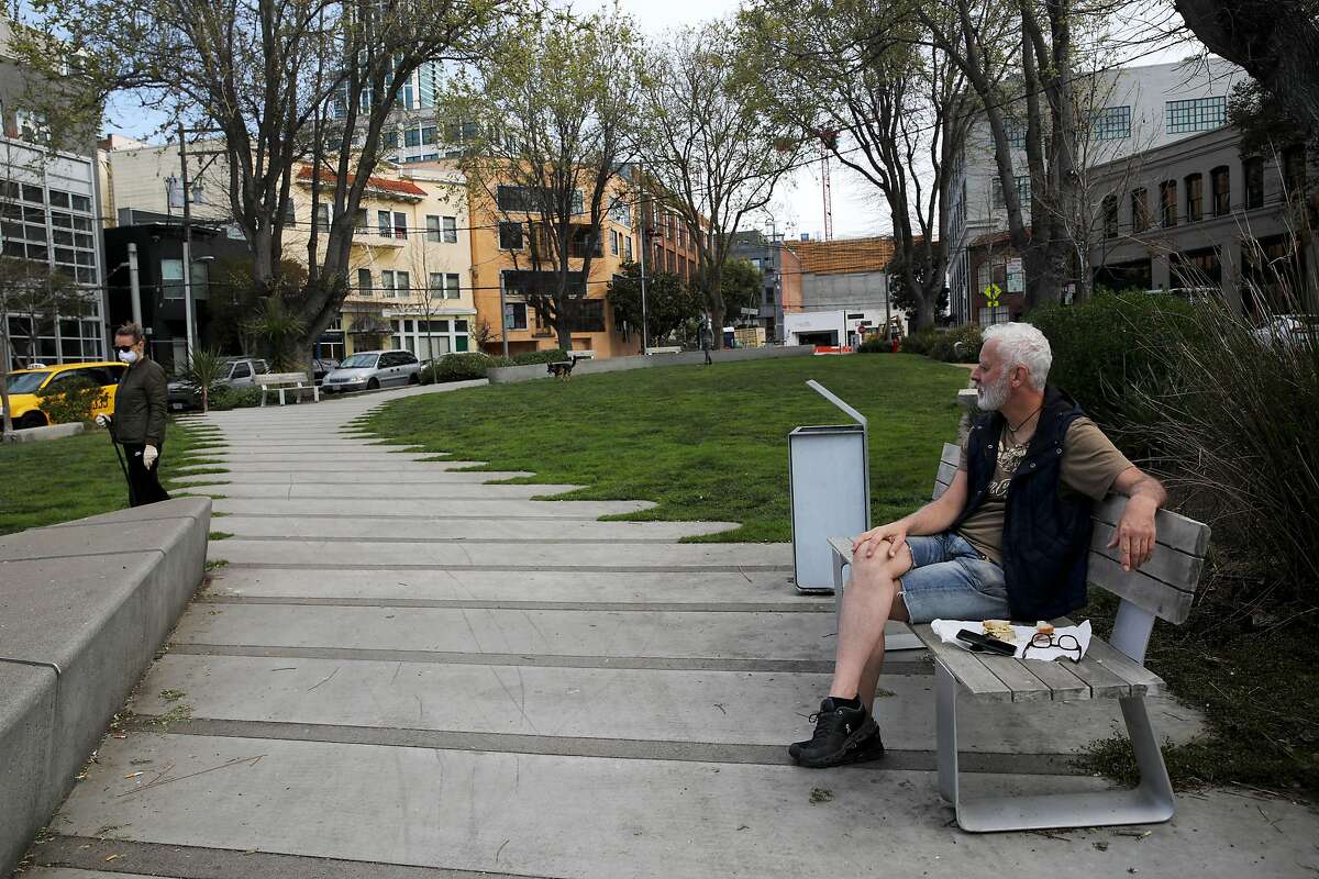 South Park resident Michael Lieberman sits quietly on a bench during his morning visit to the neighborhood park on Saturday, March 21, 2020, in San Francisco, Calif.