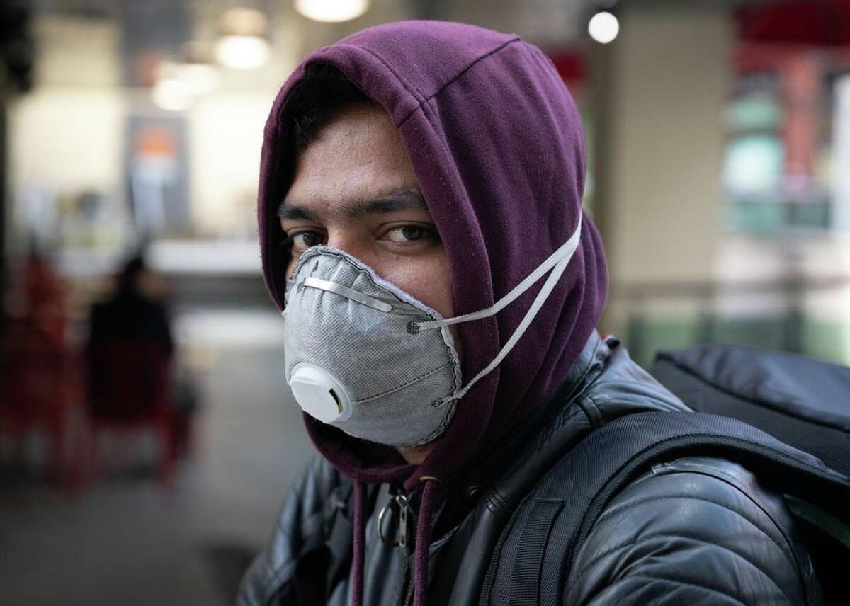 A food delivery worker in Cardiff, Wales, is seen wearing an N95 mask on March 8. Although many Laredoans immediately condemned the idea, starting Thursday they will have to wear something that covers their nose and mouth if they enter any building that is not their house, such as H-E-B, gas stations and even their place of work.