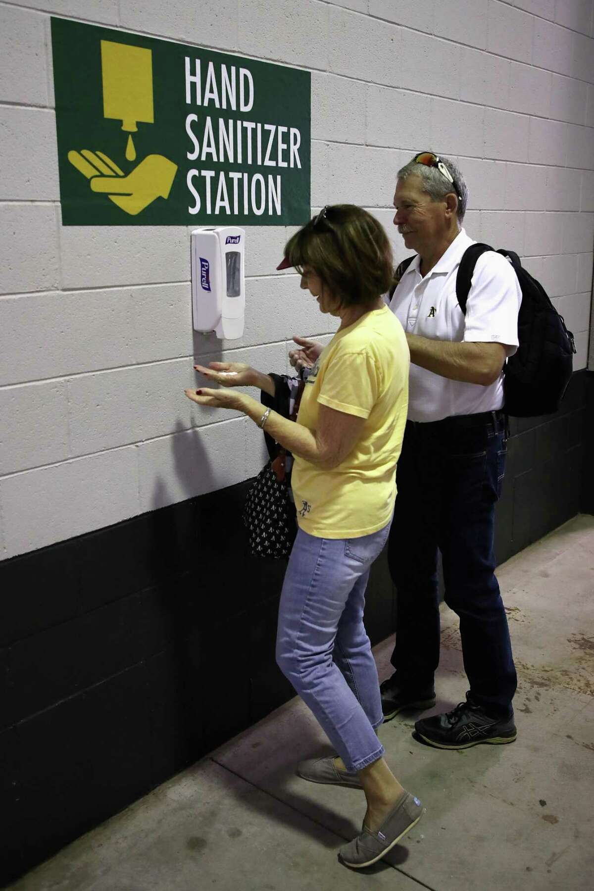 MESA, ARIZONA - MARCH 10: Fans use hand sanitizer stations along the concourse before the MLB spring training game between the Kansas City Royals and the Oakland Athletics at HoHoKam Stadium on March 10, 2020 in Mesa, Arizona. (Photo by Christian Petersen/Getty Images)