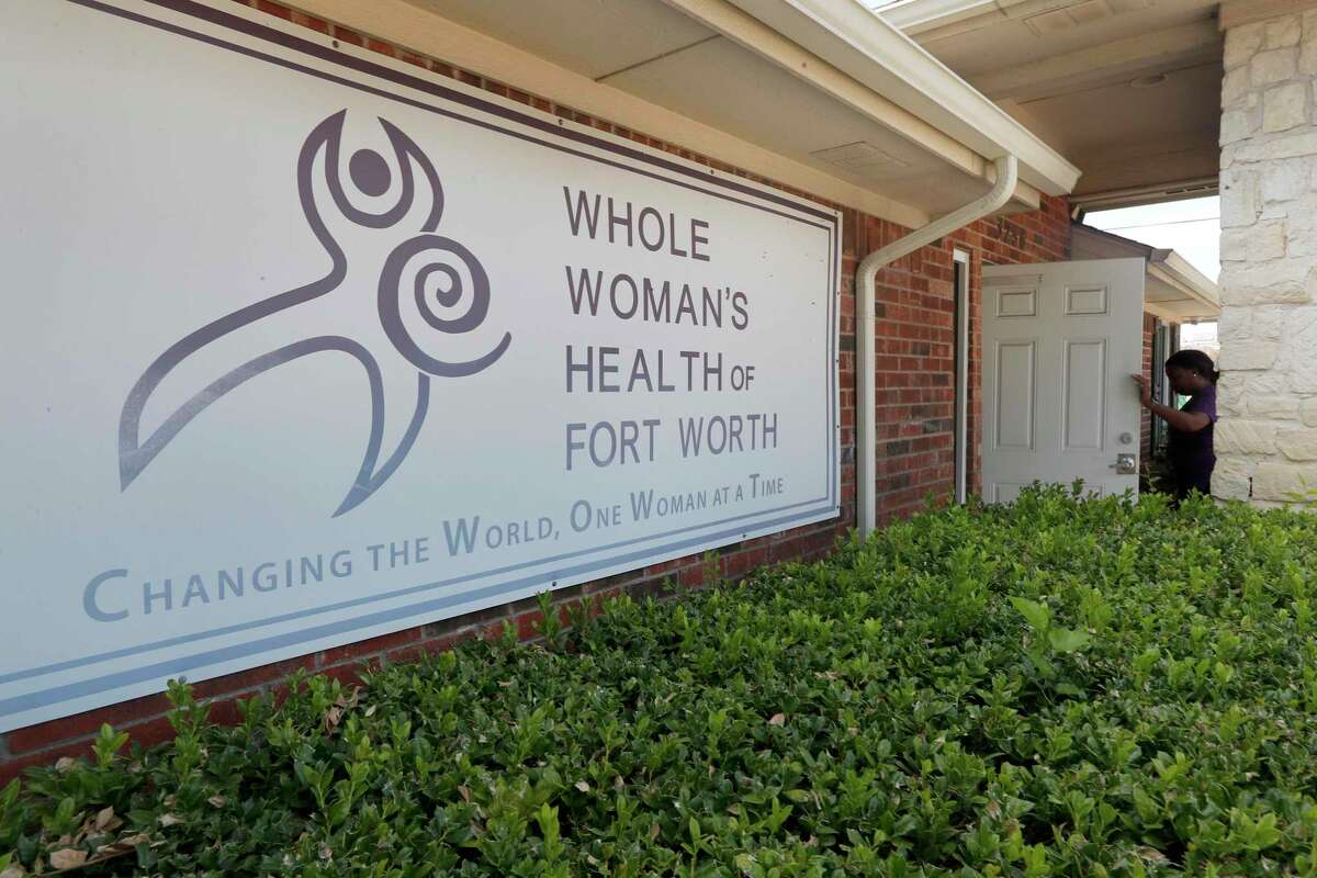 Clinic manager Angelle Harris walks in the front door of the Whole Woman's Health clinic in Fort Worth, Texas, Wednesday, Sept. 4, 2019. Faced with drives of four hours or more to Fort Worth, Dallas, El Paso or out-of-state clinics, many women in West Texas and the Panhandle need at least two days to obtain an abortion _ a situation that advocates say exacerbates the challenges of arranging child care, taking time off work and finding lodging. Some end up sleeping in their cars. (AP Photo/Tony Gutierrez)