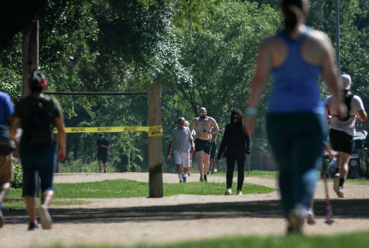 People run in Memorial Park on Wednesday, March 25, 2020, in Houston. >>See more before and after photos in the images that follow...