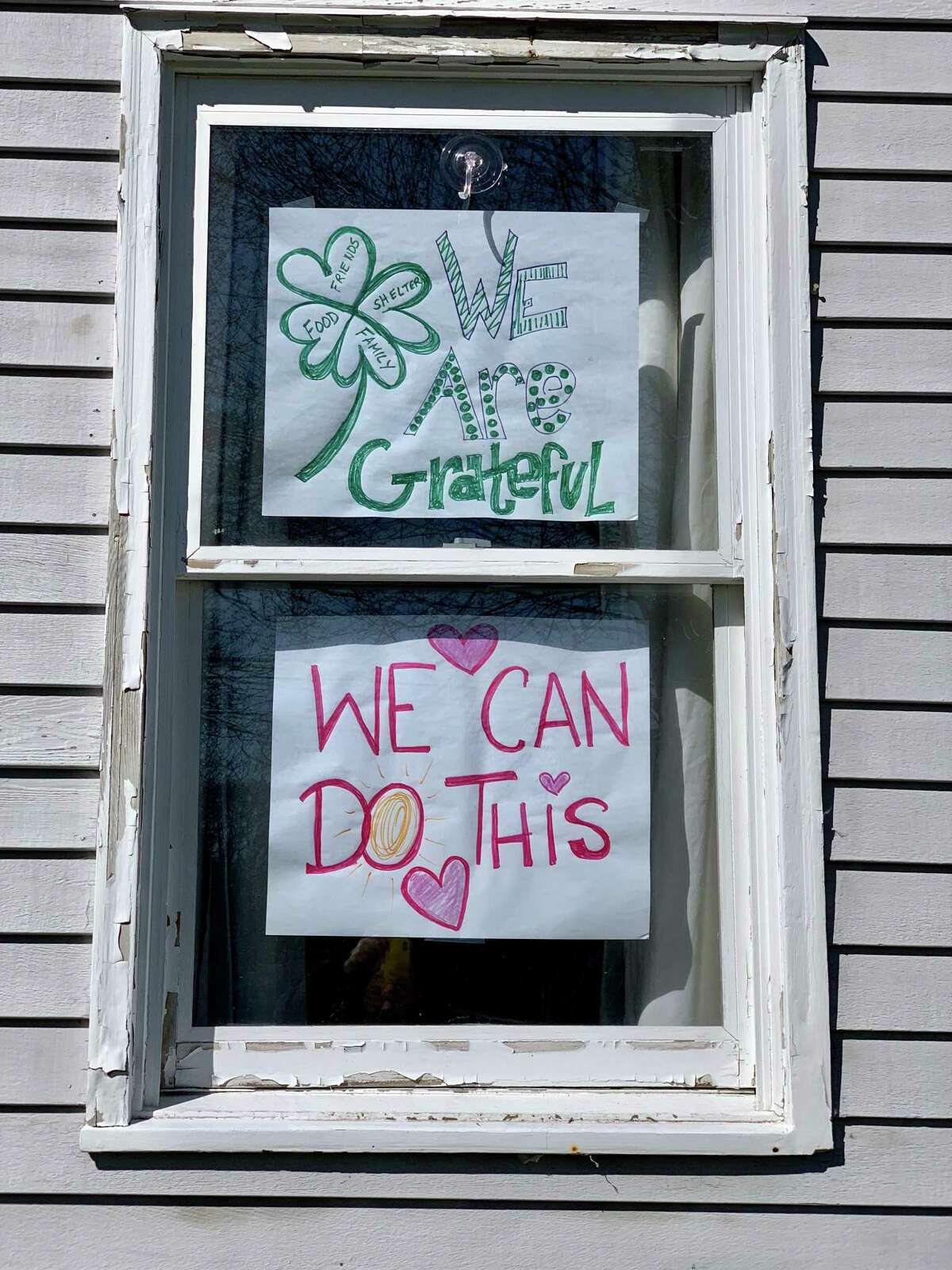 Nicole Lyons and her children - Liam, 12 and Brinley. 9, have shared encouraging messages in the windows of their Darien home.