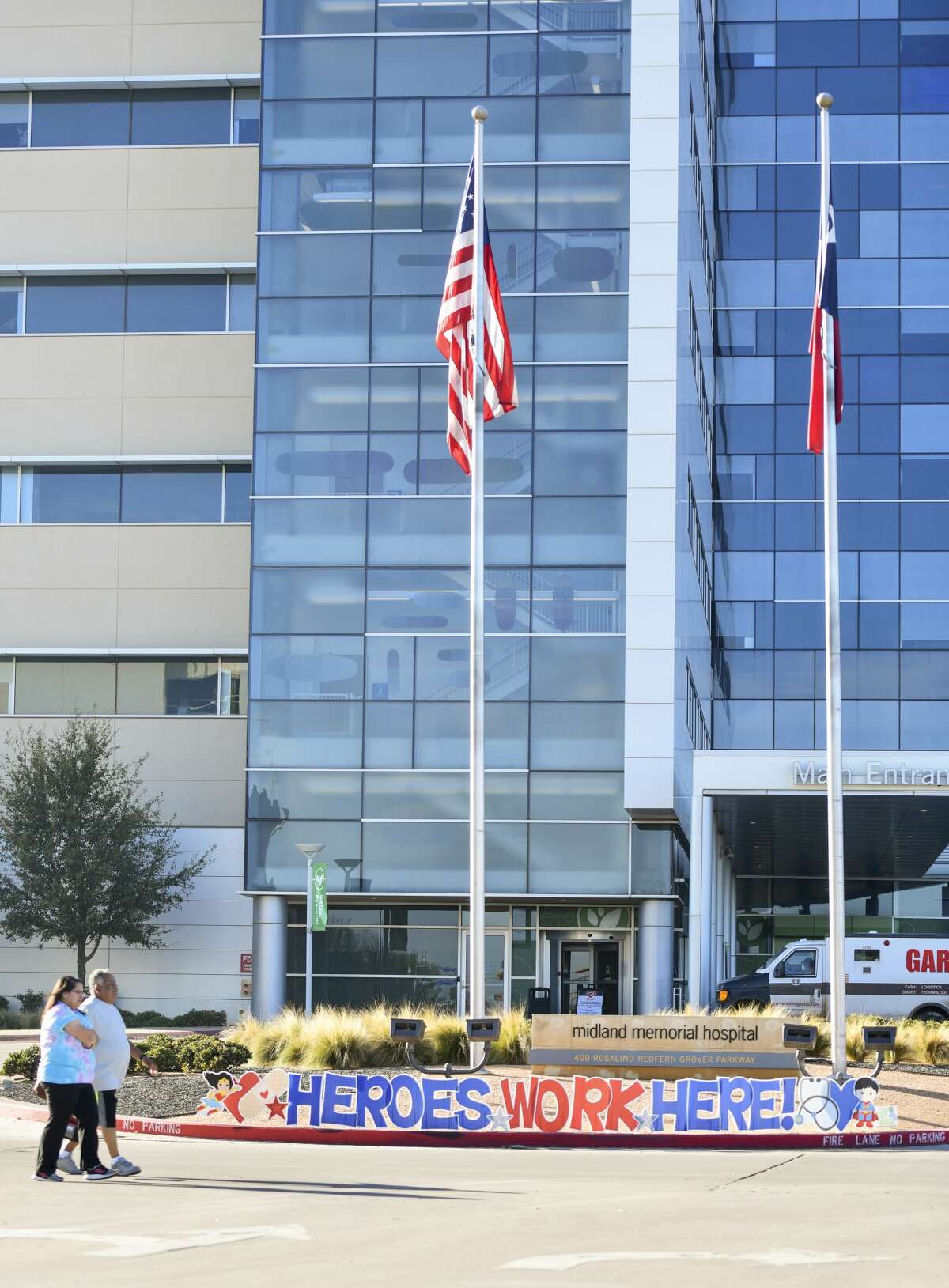 A 'Heroes Work Here!' sign is displayed at the front of the hospital enterance Thursday, March 26, 2020 at Midland Memorial Hospital.