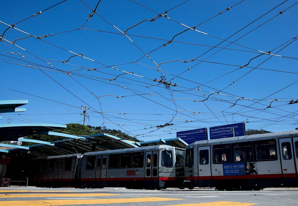 A tangle of cables are seen across the intersection of West Portal Avenue and Ulloa Street as a MUNI train enters the West Portal Station in the West Portal district of San Francisco, Calif. Thursday, September 19, 2019.