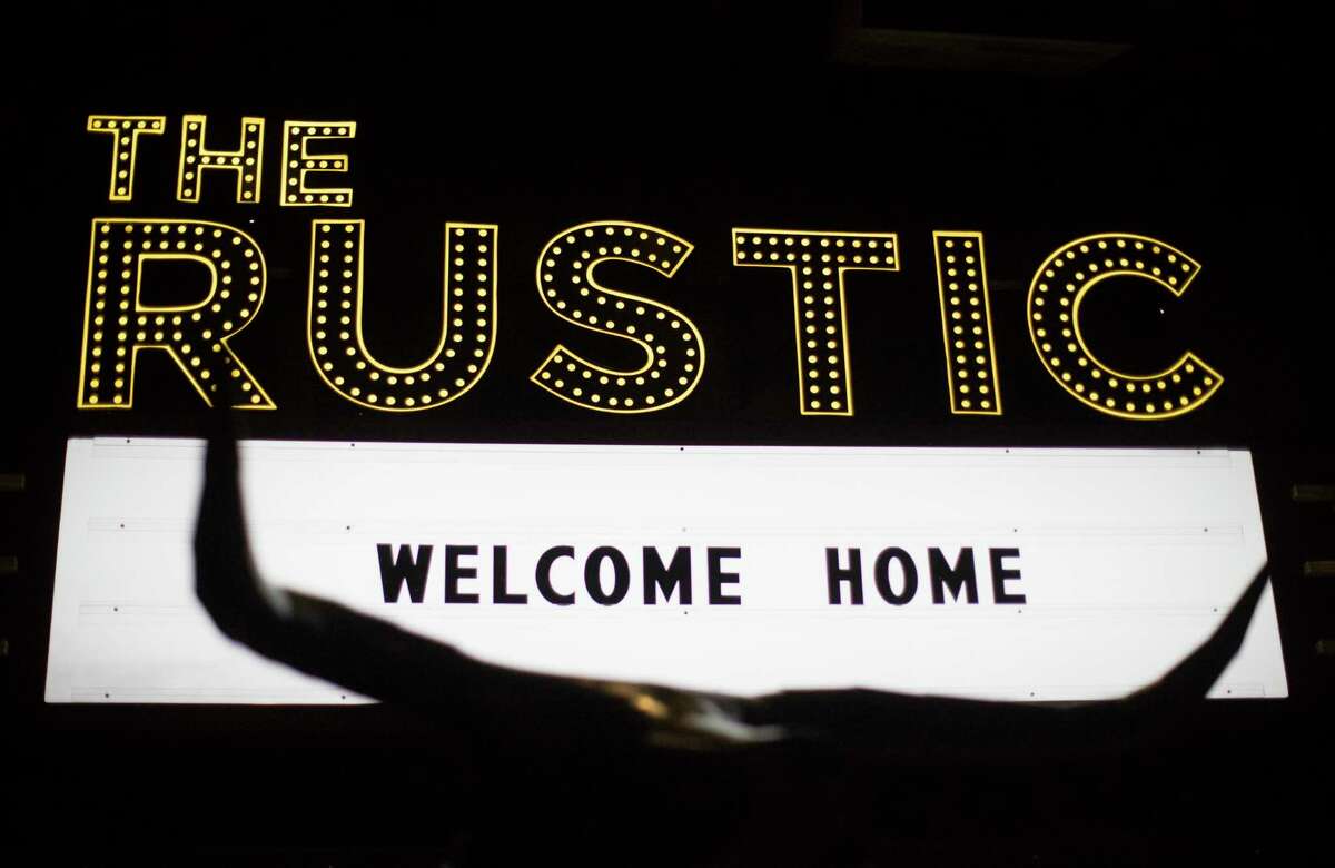 The Rustic sign shine at the entrance of the venue during the opening of the restaurant which also has a music stage and a bar, Thursday, Nov. 1, 2018, in Houston.