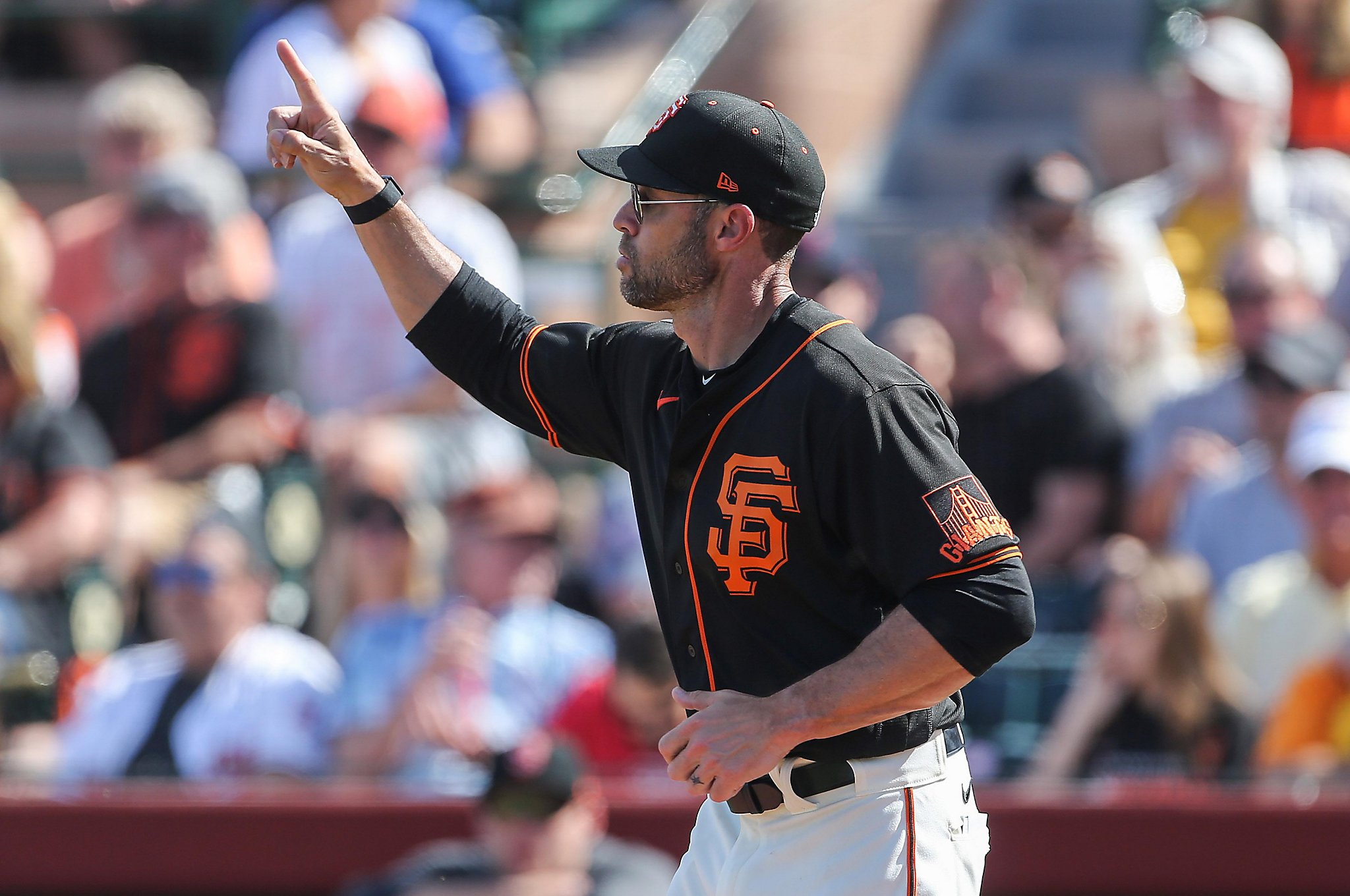 San Francisco Giants hitting coach Justin Viele sits in the dugout after a  baseball game against