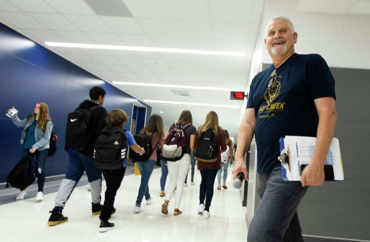 Lake Creek Principal Phil Eaton shares a laugh as students walk the hallway on the first day of school for Montgomery ISD's new Lake Creek High School on Tuesday, Aug. 21, 2018, in Montgomery.
