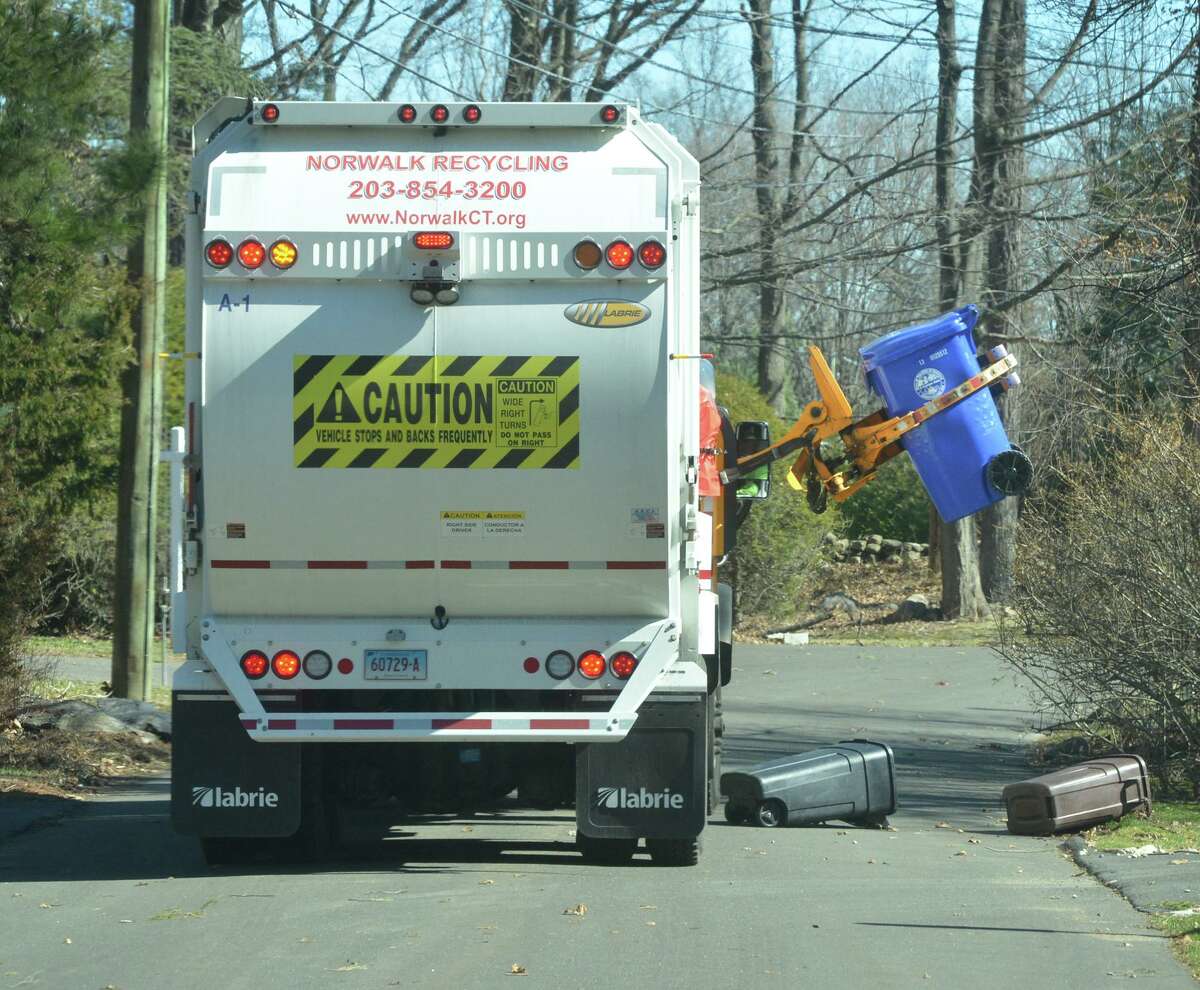 A City Carting truck picks up the recycle bins along his route in the Wolfpit section of Norwalk Conn. on Thursday March 2, 2017.