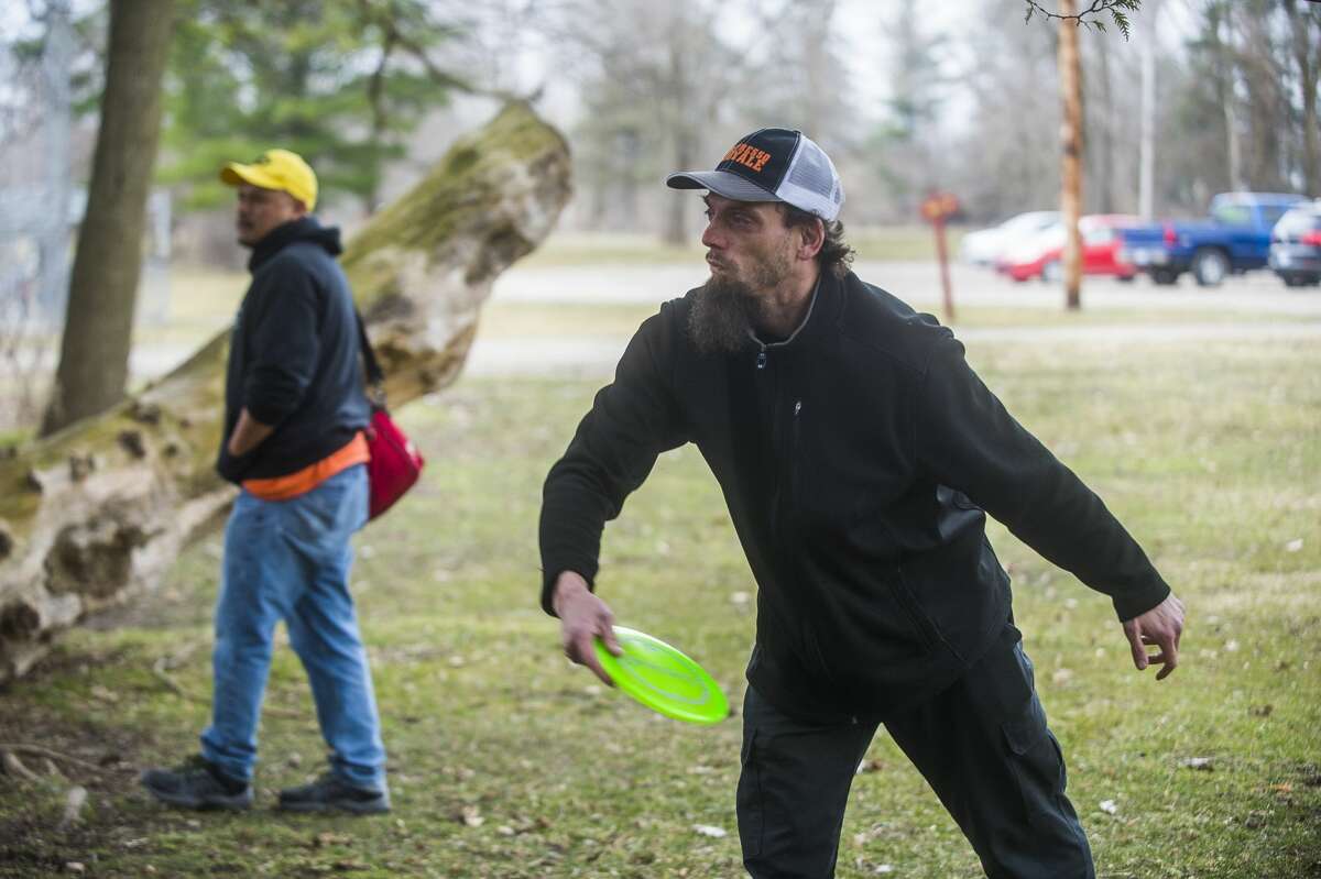 Jeremy Kopke, right, and Anthony Guisbert, left, play a round of disc golf Thursday, March 26, 2020 at the Redcoats Softball Complex in Midland. (Katy Kildee/kkildee@mdn.net)