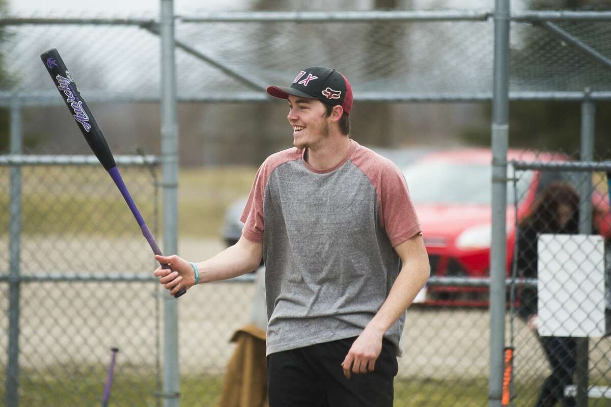 d'Artagnan Booth, 21, plays softball with friends Thursday, March 26, 2020 at the Redcoats Softball Complex in Midland. (Katy Kildee/kkildee@mdn.net)