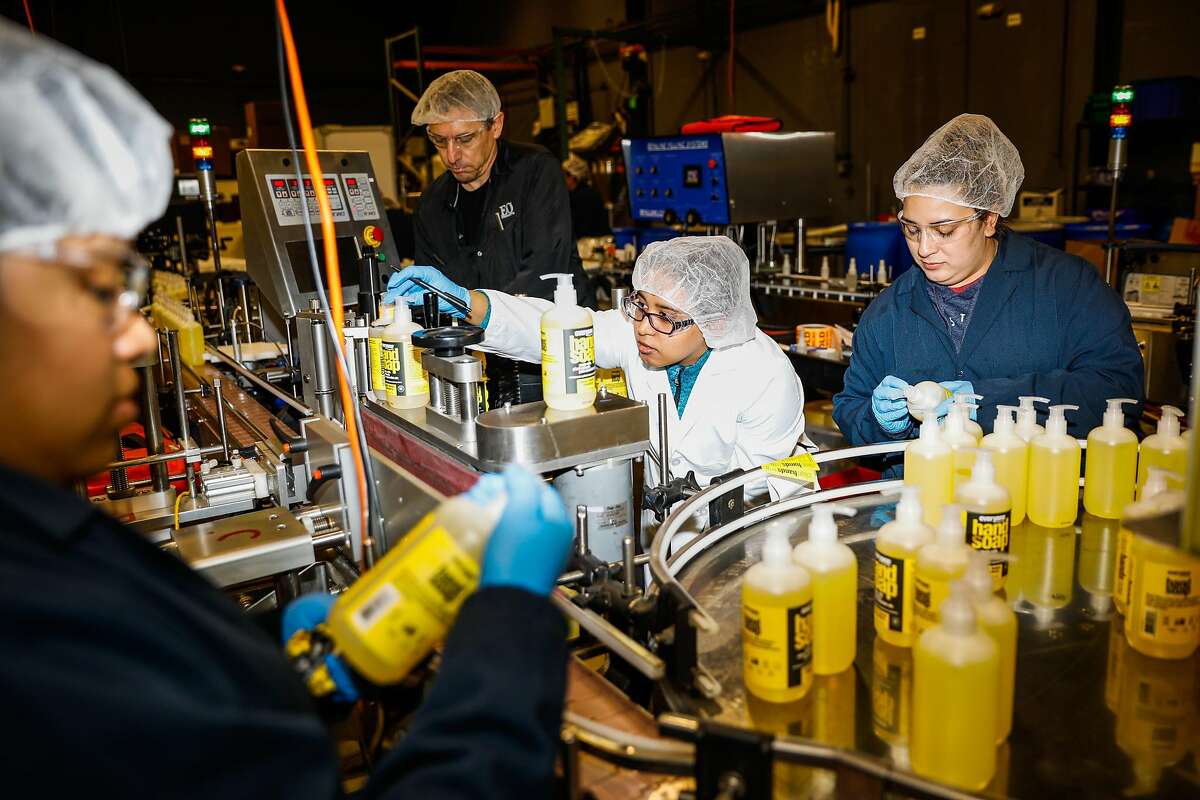Employees work at the EO factory on Monday, March 23, 2020 in San Rafael, California. They have seen the need for their product grow by over 1000% in the last month.