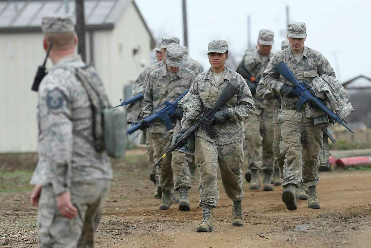 Air Force basic trainees march with mock M-16s to the next obstacle at Joint Base San Antonio-Lackland in 2018. Coronavirus concerns have prompted commanders to prepare an alternate training site at Keesler AFB in Biloxi, Mississippi, to open April 7. (Kin Man Hui/San Antonio Express-News)