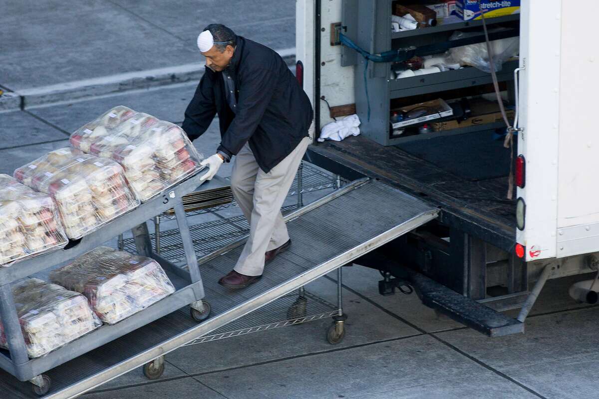 A man transports coffee and food for various San Francisco city departments in Moscone Center on Howard Street in San Francisco, Calif. Thursday, March 26, 2020. San Francisco is currently using Moscone Center as their emergency operations center as residents shelter-in-place due to the outbreak of the Coronavirus.