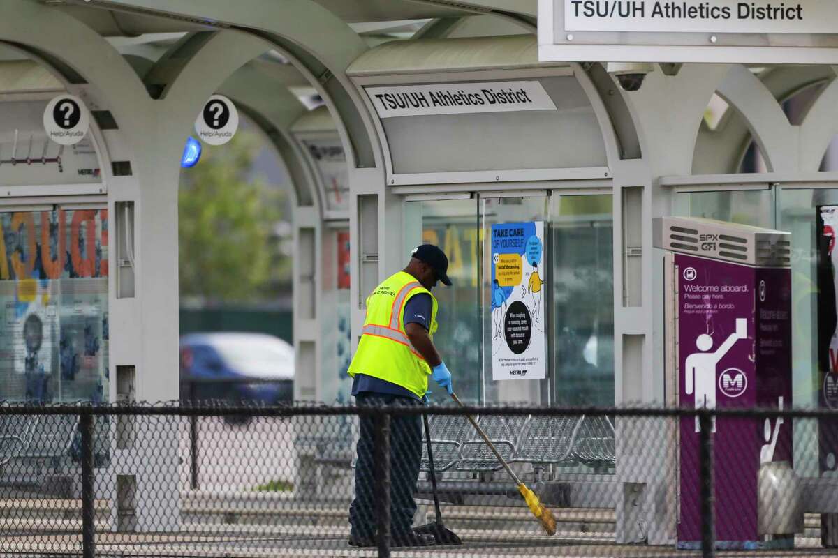 A Metropolitan Transit Authority worker cleans the TSU/UH Athletics District light rail stop on March 26, 2020, near the University of Houston.