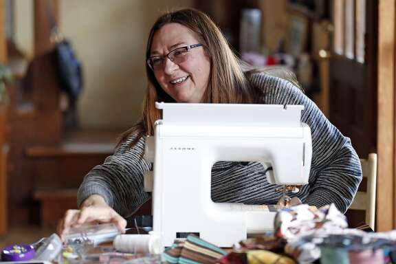 Nurse Cherie Klein works on making face masks, for herself and her colleagues, at her home in Fairfax, Calif., on Wednesday, March 25, 2020.